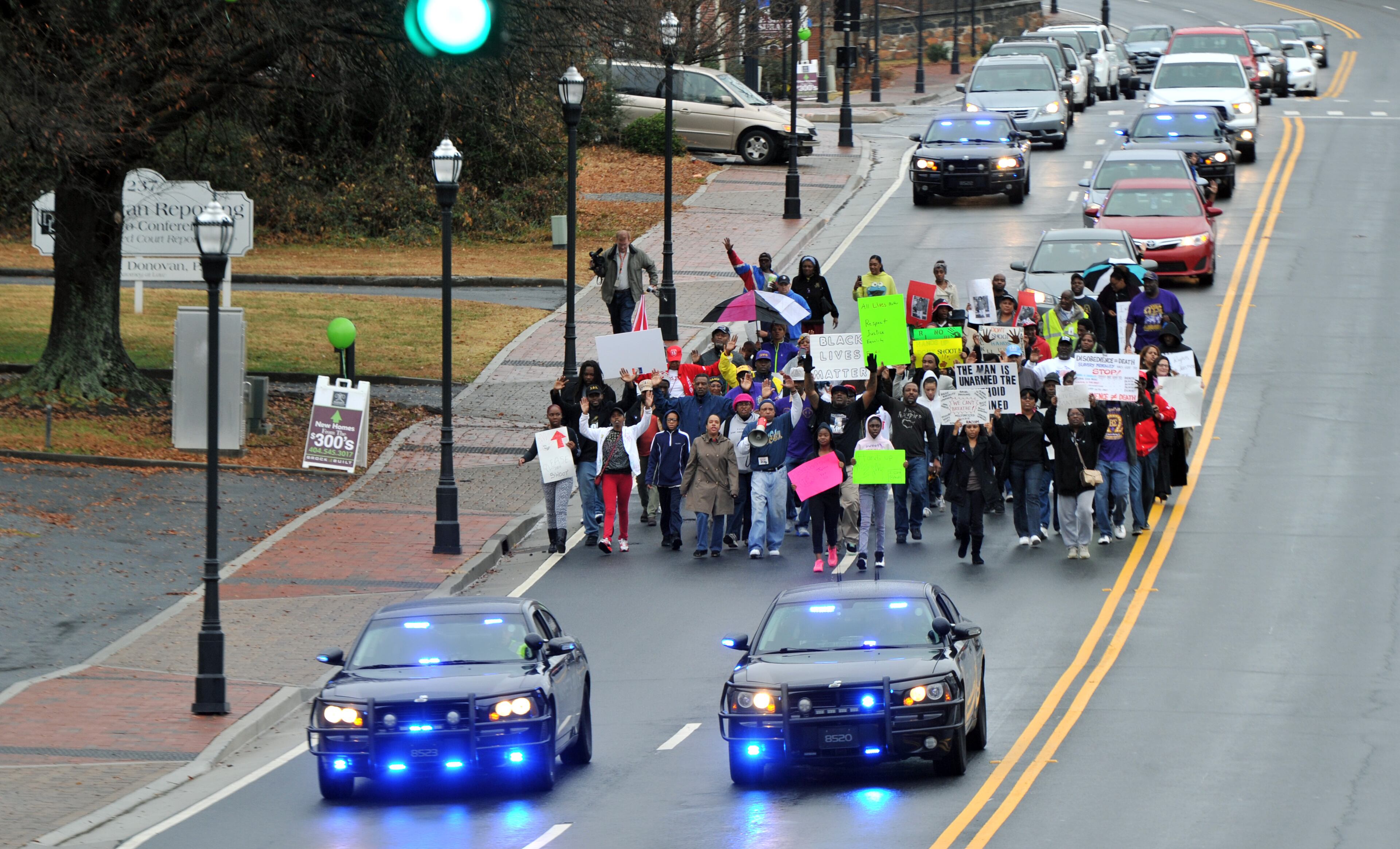 December 6, 2014 Marietta - Protesters march toward the Marietta Square during their peaceful demonstration against decisions not to indict white police officers in the deaths of unarmed black men in Ferguson, Mo., and in New York City on Saturday, December 6, 2014. HYOSUB SHIN / HSHIN@AJC.COM