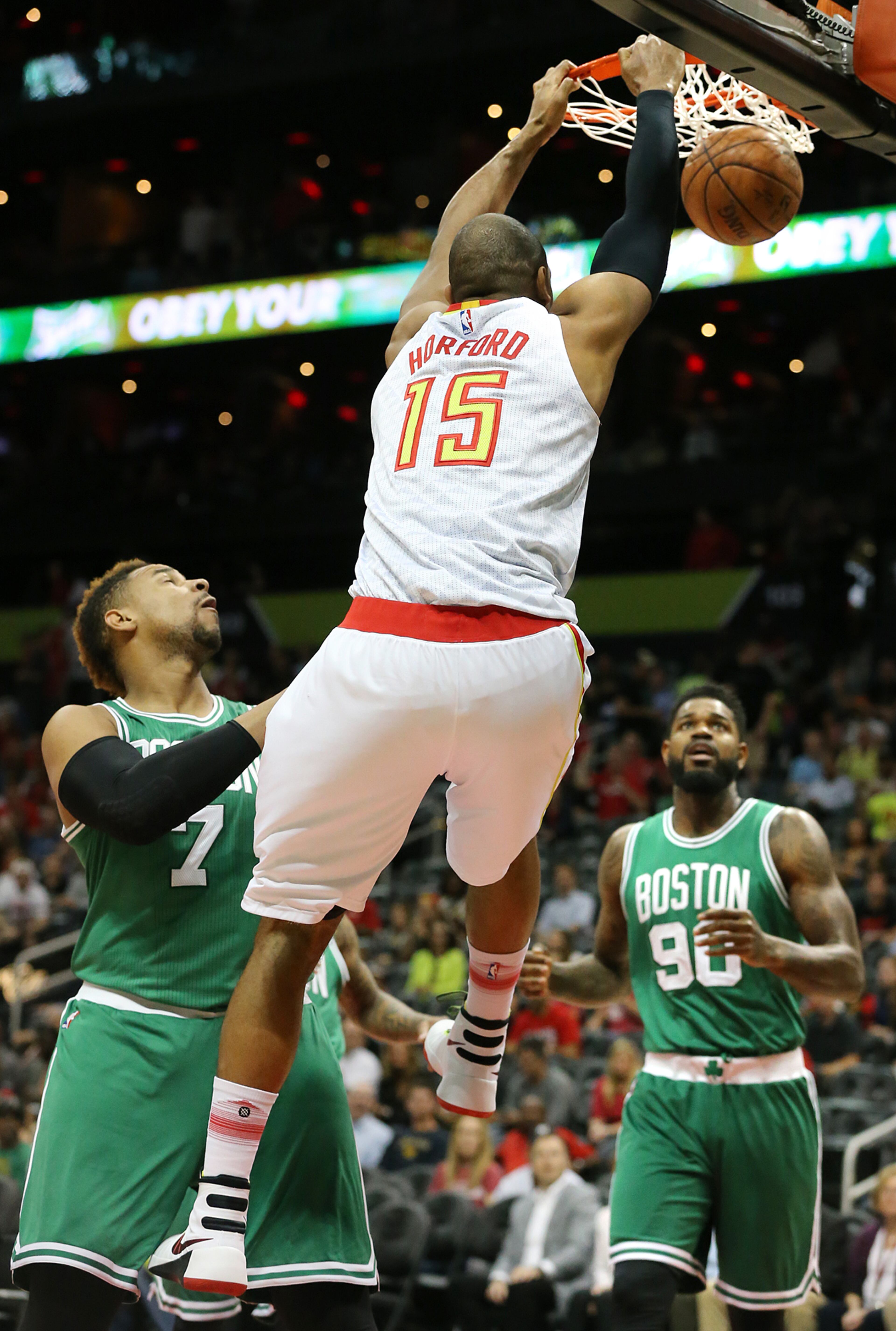 Al Horford slams for two over Celtics Jared Sullinger and Amir Johnson. Curtis Compton / ccompton@ajc.com