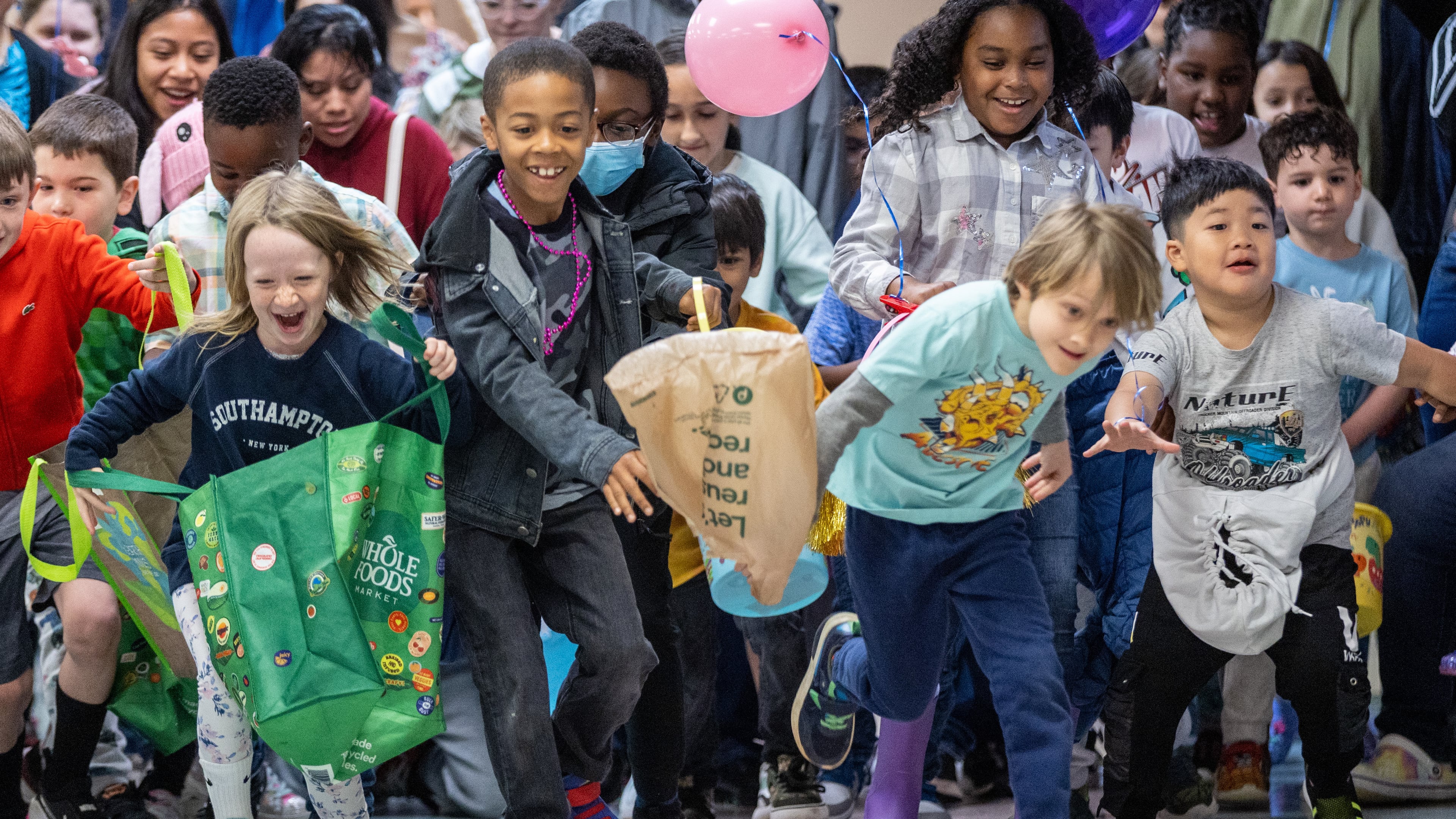 Kids race to gather eggs at the Mason Mill Park and Bridgepoint Church during an indoor Easter egg hunt in April 2023. The event was moved inside because of rain that year. The forecast calls for another wet holiday this year. (Steve Schaefer/AJC 2023)