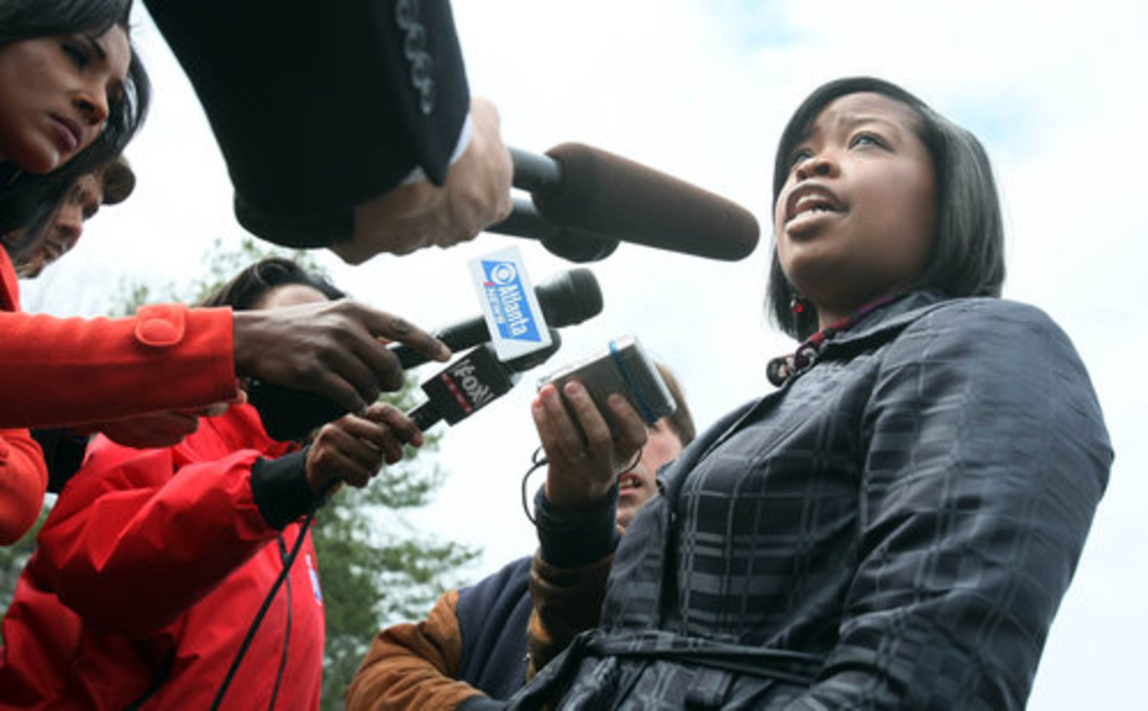 DeKalb County Public Information Officer Mekka Parrish talks to members of the media after police detained a 17-year-old Columbia High student once believed to have carried a gun onto campus fled the school today.