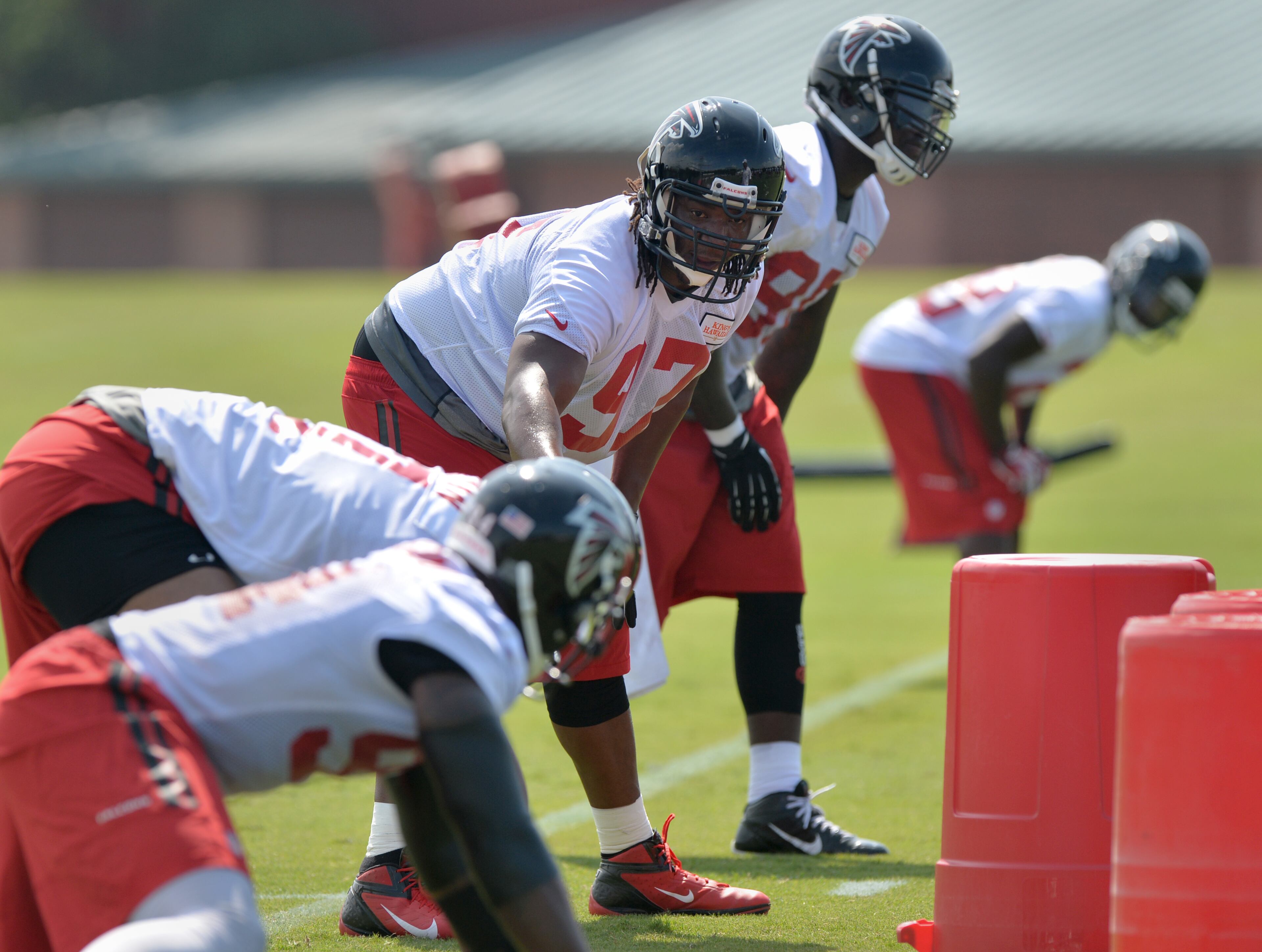 Atlanta Falcons defensive end Jonathan Massaquoi leads a drill during training camp on Friday, July 25, 2014.