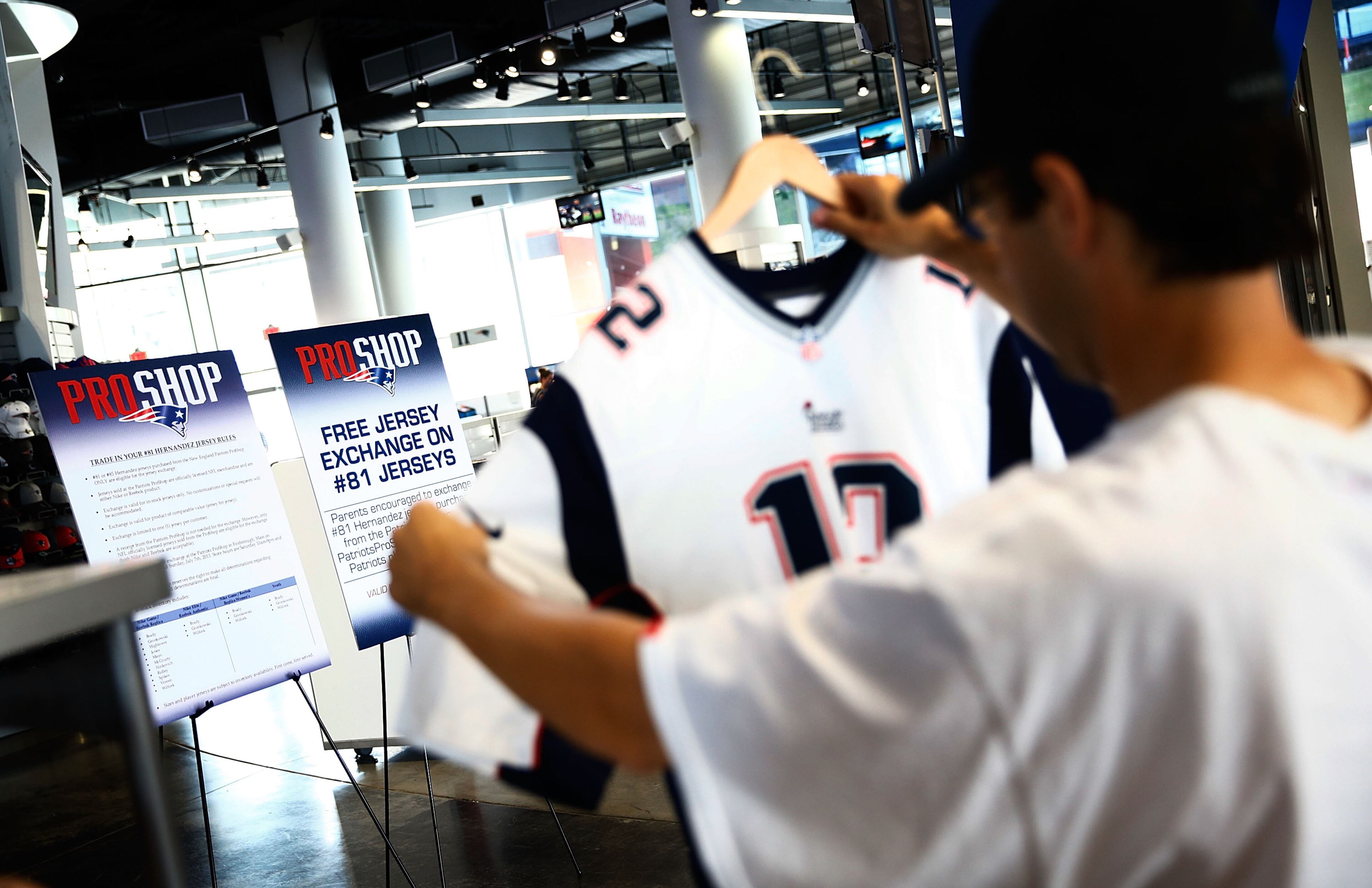 FOXBORO, MA - JULY 7: New England Patriots fans trade in their Aaron Hernandez jerseys during a free exchange at the pro shop at Gillette Stadium on July 7, 2013 in Foxboro, Massachusetts. (Photo by Jared Wickerham/Getty Images)