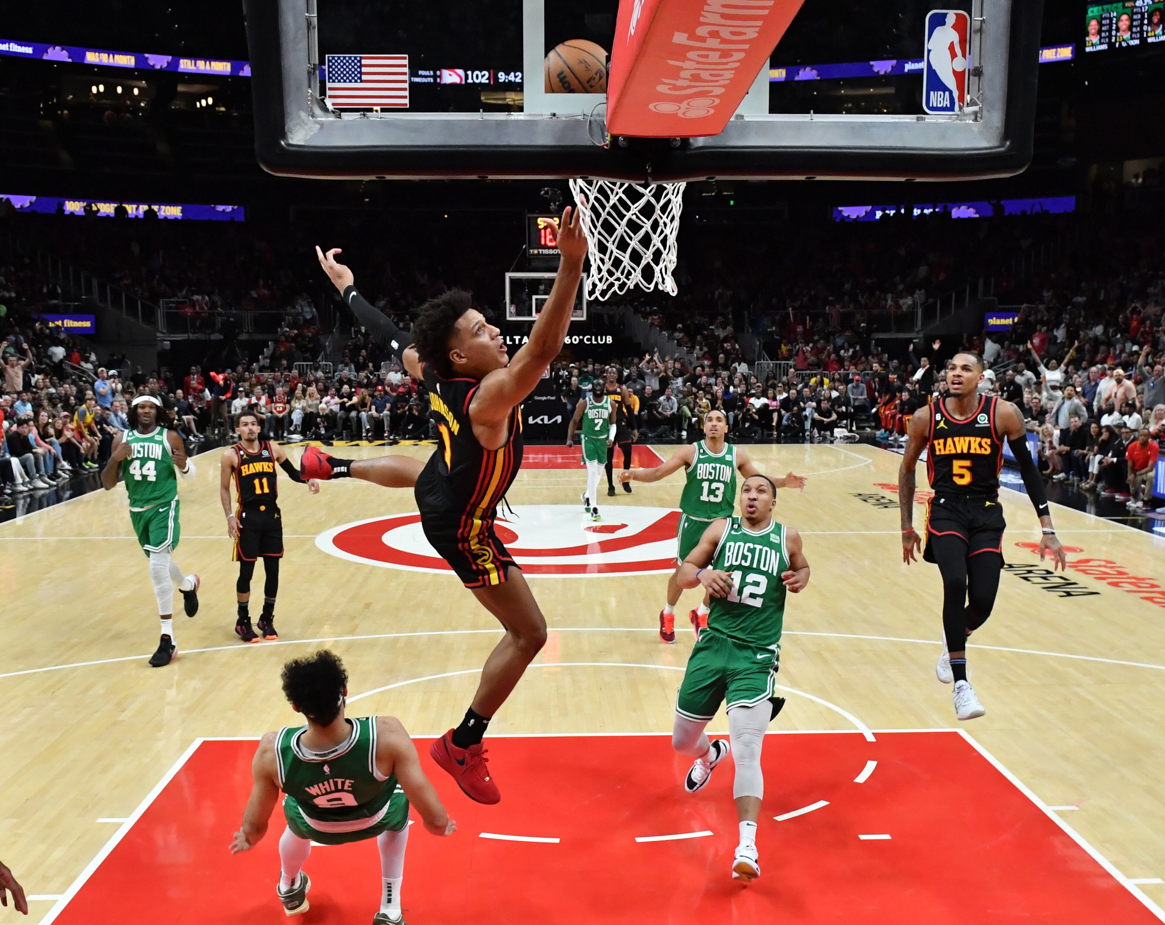 Atlanta Hawks' forward Jalen Johnson (1) falls onto Boston Celtics' guard Derrick White (9) as he goes in for a lay-up during the second half. (Hyosub Shin / Hyosub.Shin@ajc.com)