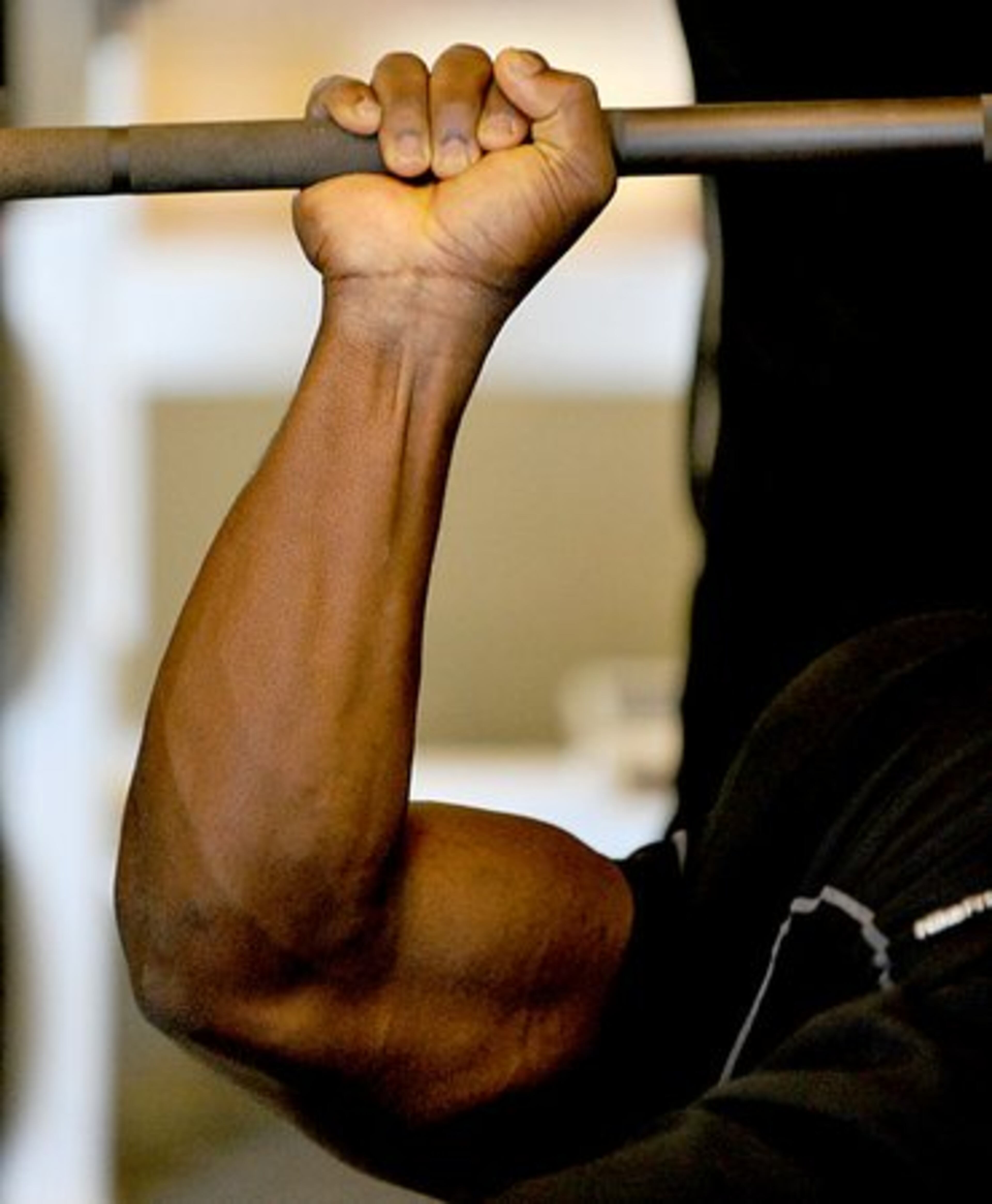 You don't get arms like that working out only once a day. Linebacker Rennie Curran, performing bench presses, works out twice a day.