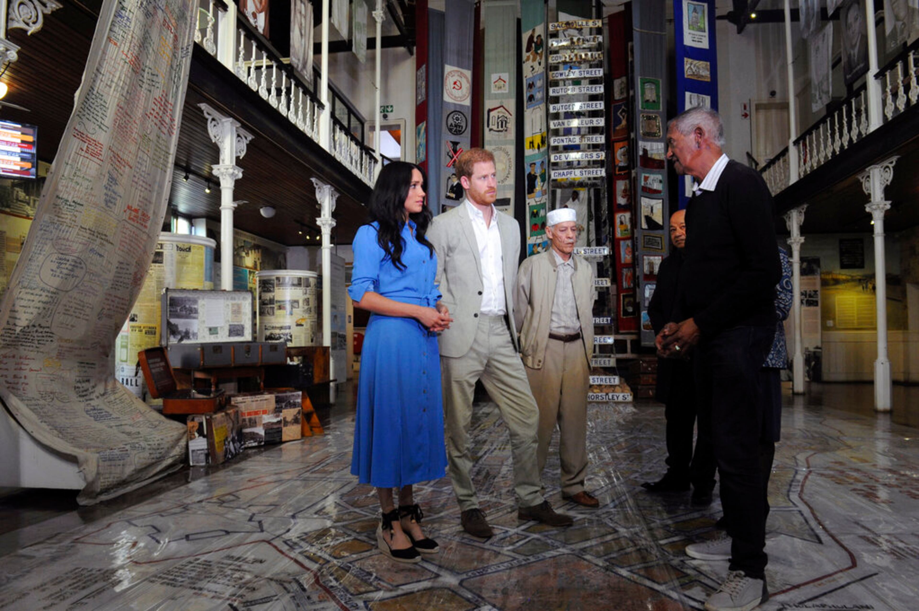 Britain's Prince Harry and Meghan, Duchess of Sussex are given a guided tour of the District Six Museum in Cape Town, South Africa, Monday, Sept, 23, 2019. The royal couple are starting their first official tour as a family with their infant son, Archie. (Henk Kruger / African News Agency via AP, Pool)