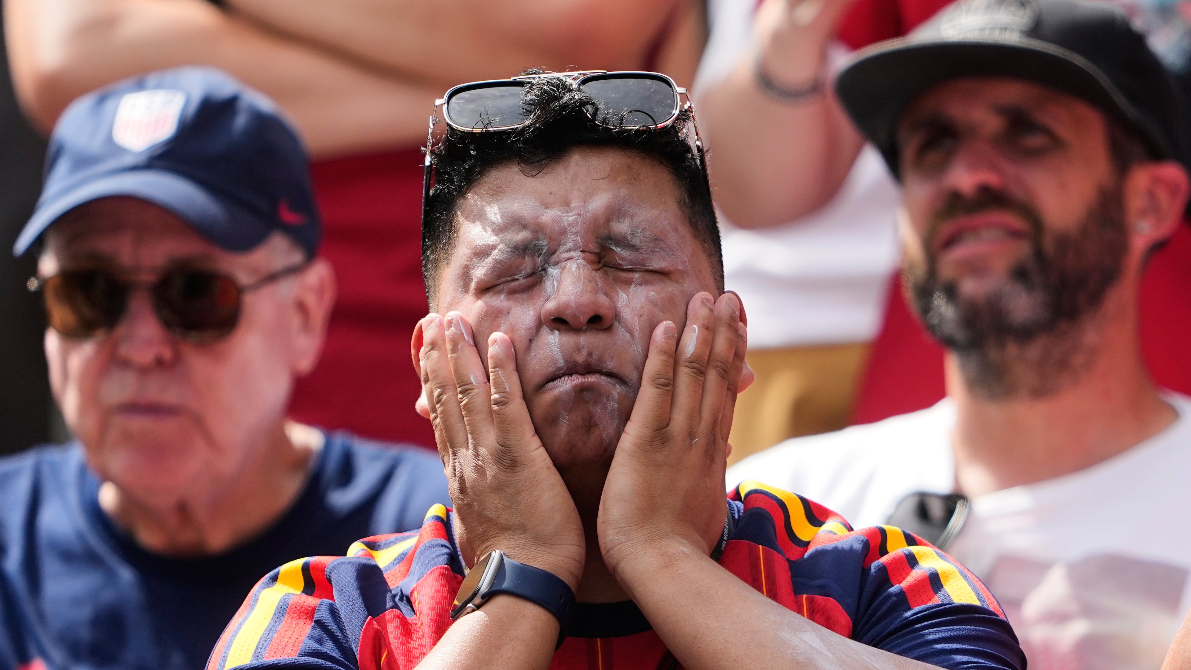 FILE - A fan puts on sunscreen prior to the World Cup Group G soccer match between Belgium and Egypt in Seattle on June 15, 2026. (AP Photo/Lindsey Wasson, File)