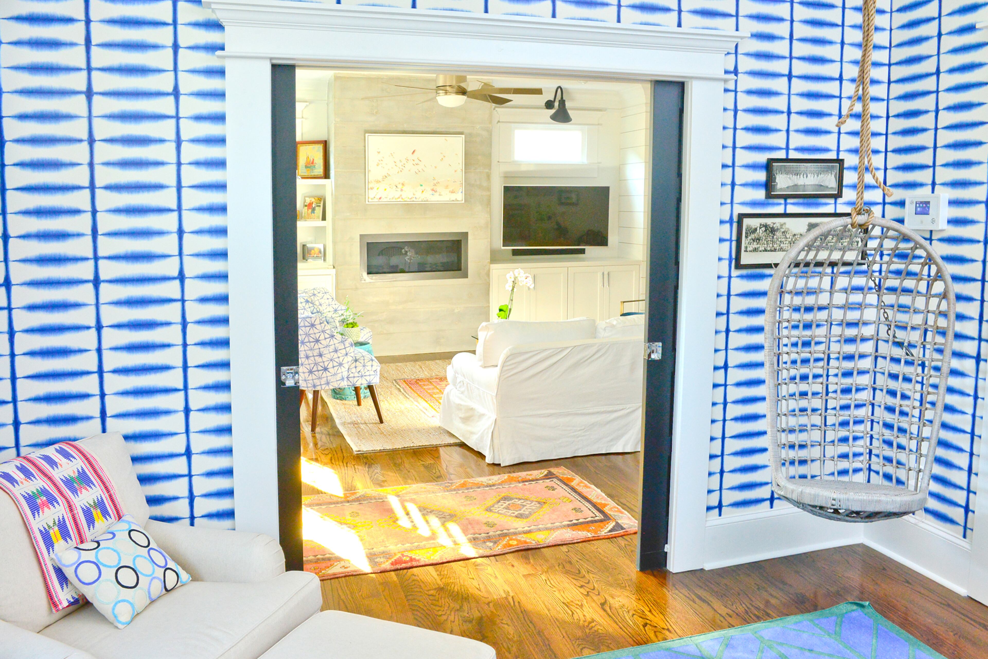 Pocket doors separate the living room and home office. The elongated entry created a decorating dilemma until White found a long, narrow rug from Kishia's Rugs and Antiques that adds color and perfectly fits the space.