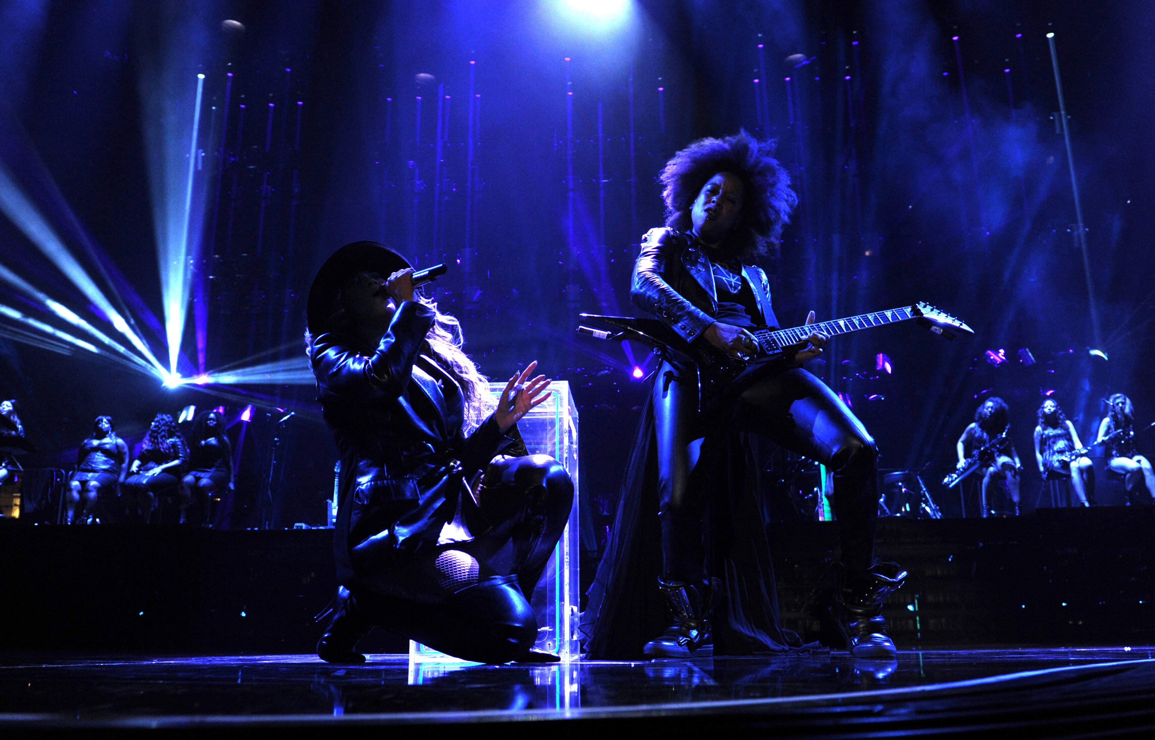 Singer Beyonce, left, and Bibi McGill perform on Beyonce's "Mrs. Carter Show World Tour 2013" during the Essence Festival at the Superdome on Sunday, July 7, 2013, in New Orleans. Beyonce is wearing a coat by Pucci. (Photo by Frank Micelotta/Invision for Parkwood Entertainment/AP Images)