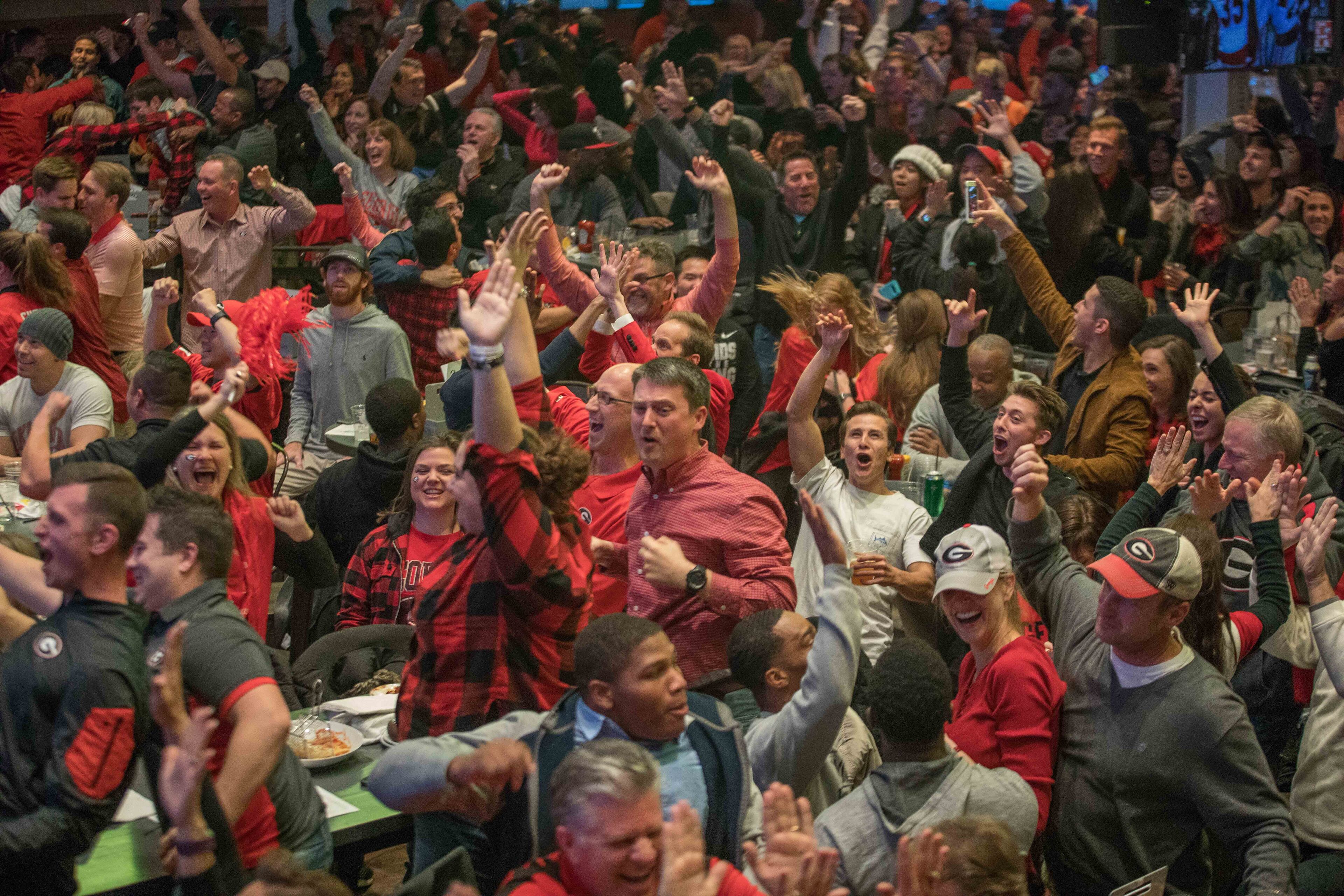 Fans react after Georgia intercepted the ball from Oklahoma during the second half of the Rose Bowl NCAA college football game, Monday, Jan. 1, 2018, in Atlanta. BRANDEN CAMP/SPECIAL