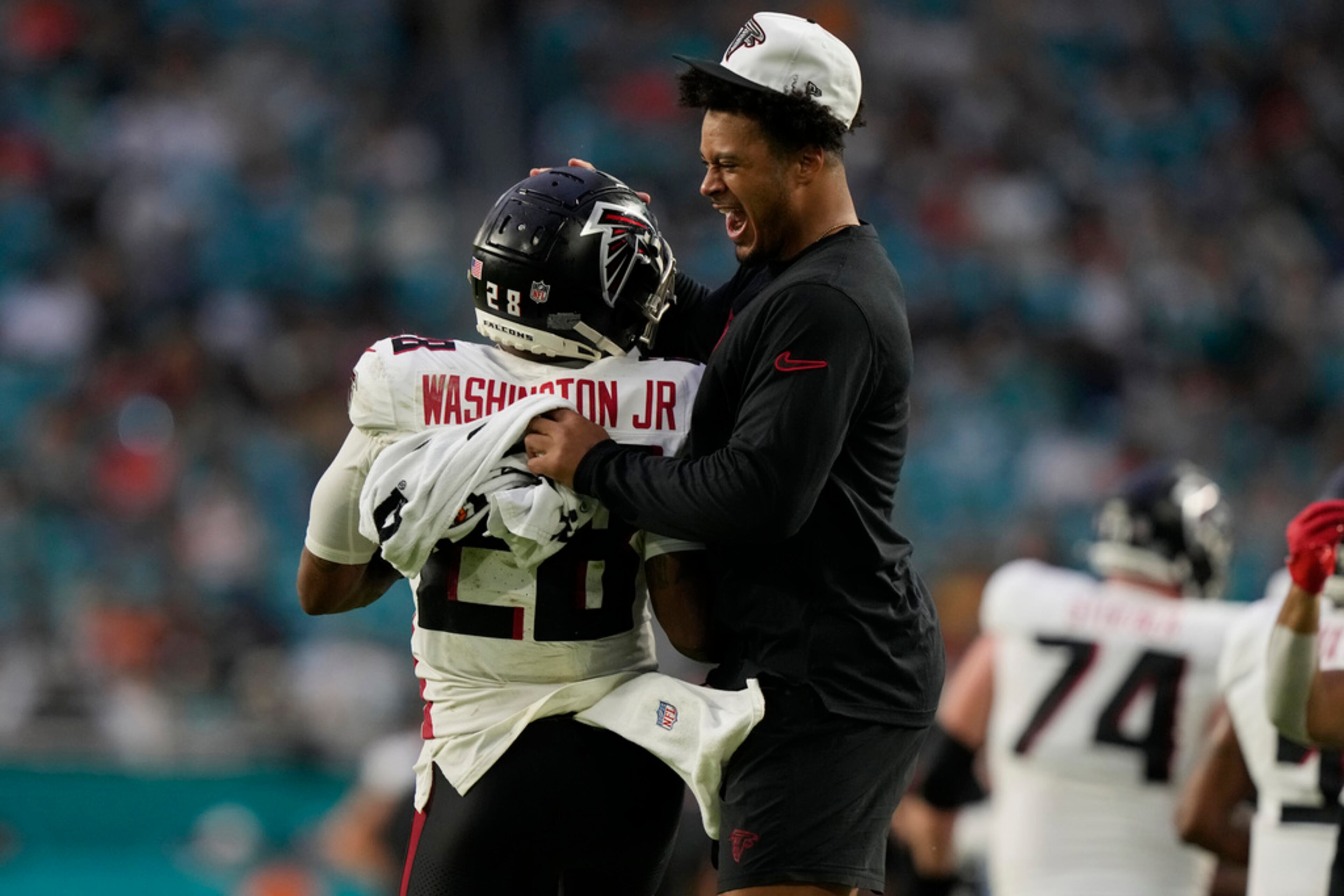 Atlanta Falcons running back Carlos Washington Jr. (28) is congratulated after scoring a touchdown during the first half of a pre season NFL football game against the Miami Dolphins, Friday, Aug. 9, 2024, in Miami Gardens, Fla. (AP Photo/Lynne Sladky)