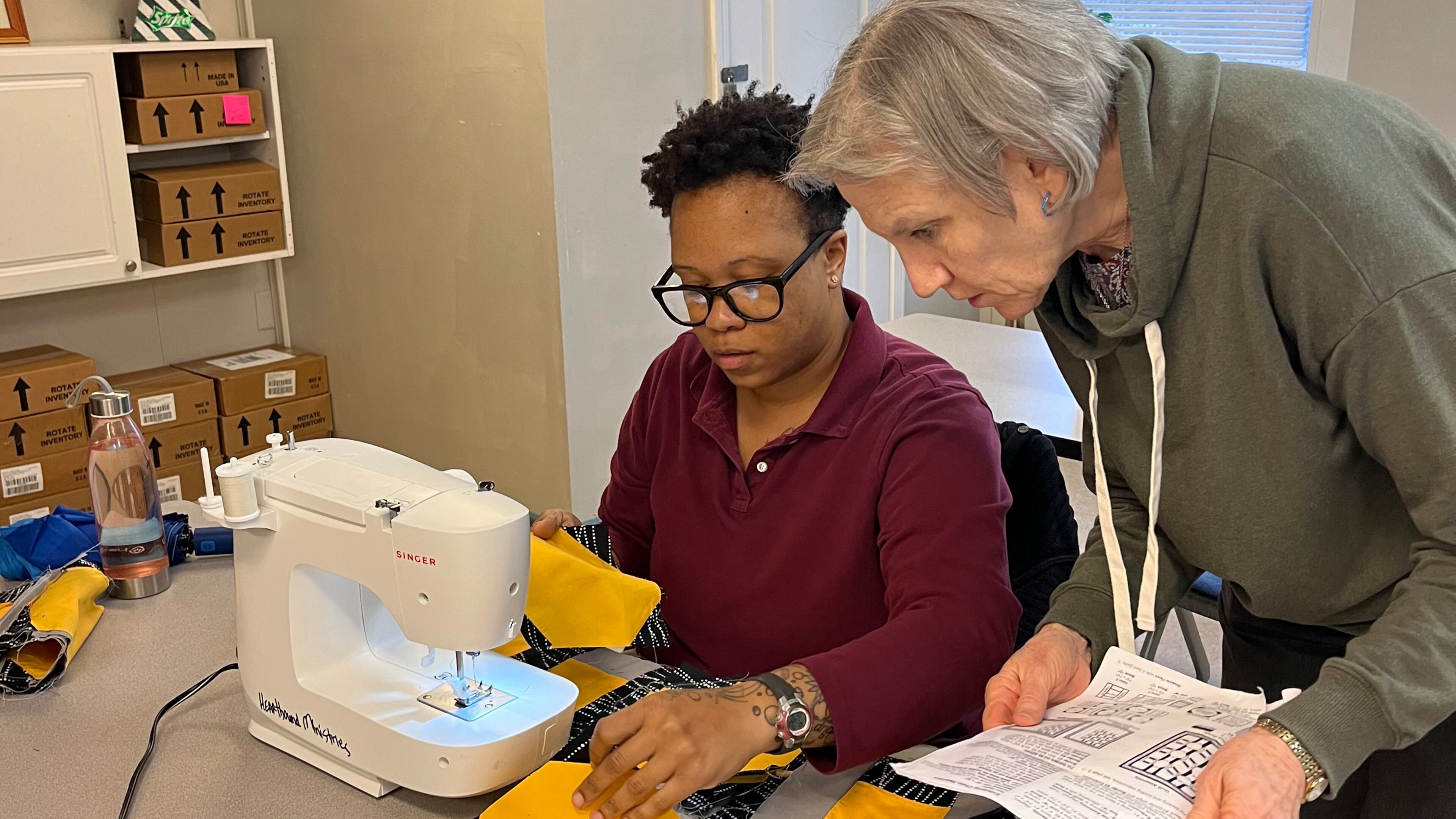 Volunteer teacher Fonde Werts helps Candice Boles with the next step of her quilt at the Women's Transitional Center.
(Courtesy HeartBound Ministries)