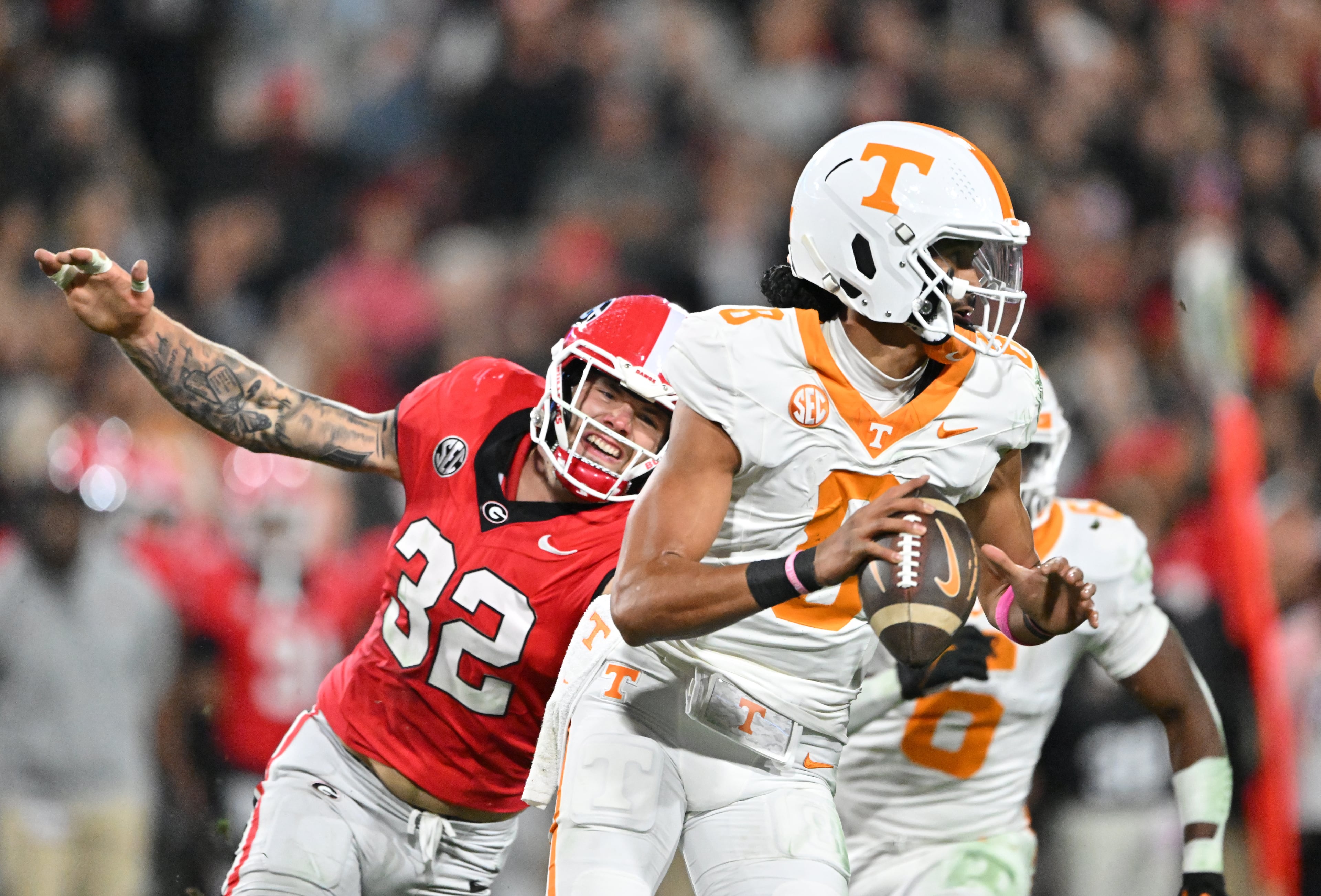 Tennessee quarterback Nico Iamaleava (8) prepares to pass under pressure from Georgia linebacker Chaz Chambliss (32) during the first half in an NCAA football game at Sanford Stadium, Saturday, November 16, 2024, in Athens. (Hyosub Shin / AJC)