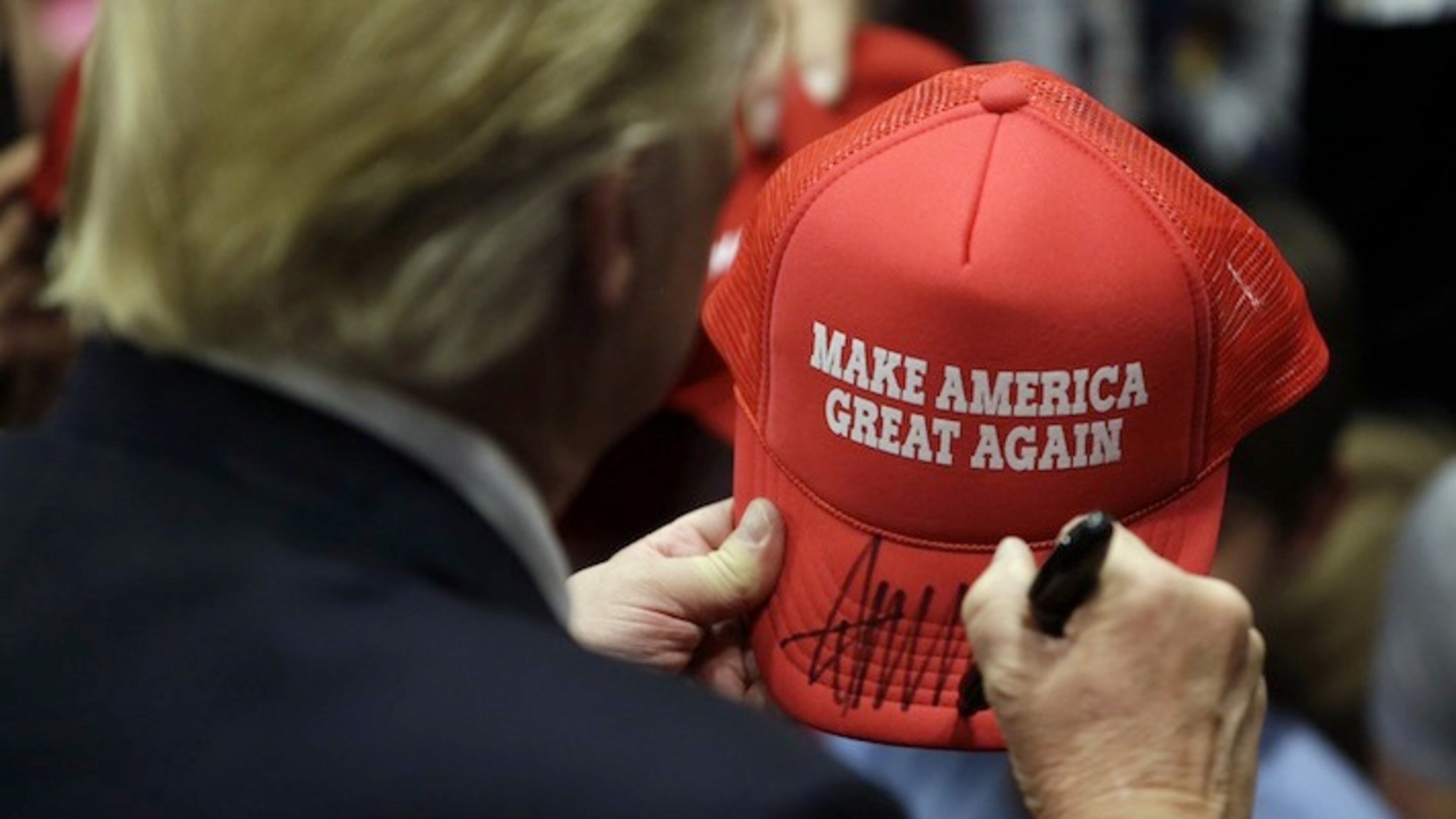 Republican presidential candidate Donald Trump signs an autograph for a supporter after speaking at a campaign rally at West Chester University, Monday, April 25, 2016, in West Chester, Pa. (AP Photo/Matt Slocum)