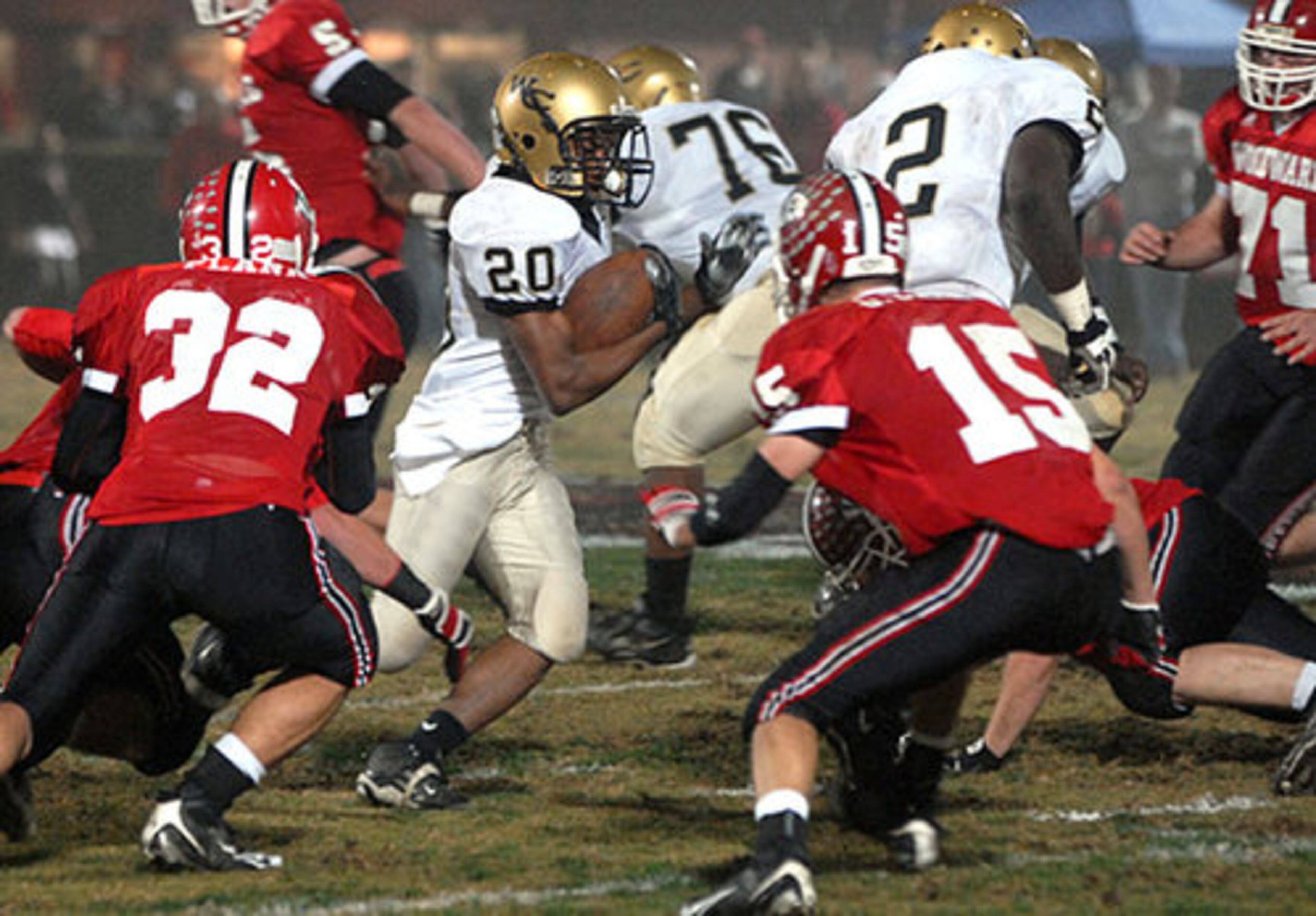 Washington County's Montravoius Gladden (No. 20) plows through the crowd during the first quarter.