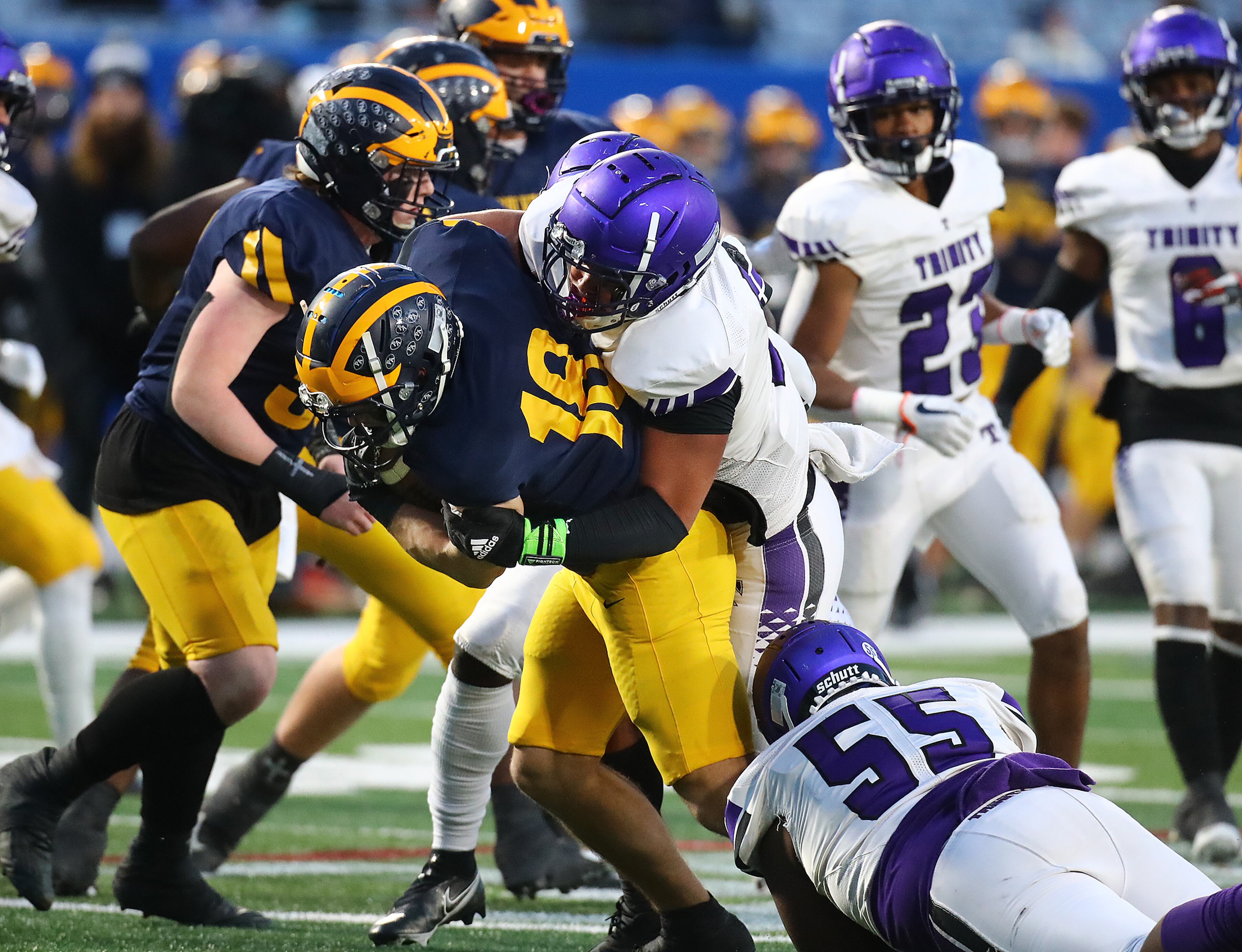 Trinity Christian middle linebacker Josiah Johnson levels Prince Avenue Christian running back Luke Lanier at the line of scrimmage for no gain during the first quarter in their GHSA Class A Private Championship game on Thursday, Dec 9, 2021, in Atlanta. “Curtis Compton / Curtis.Compton@ajc.com”`
