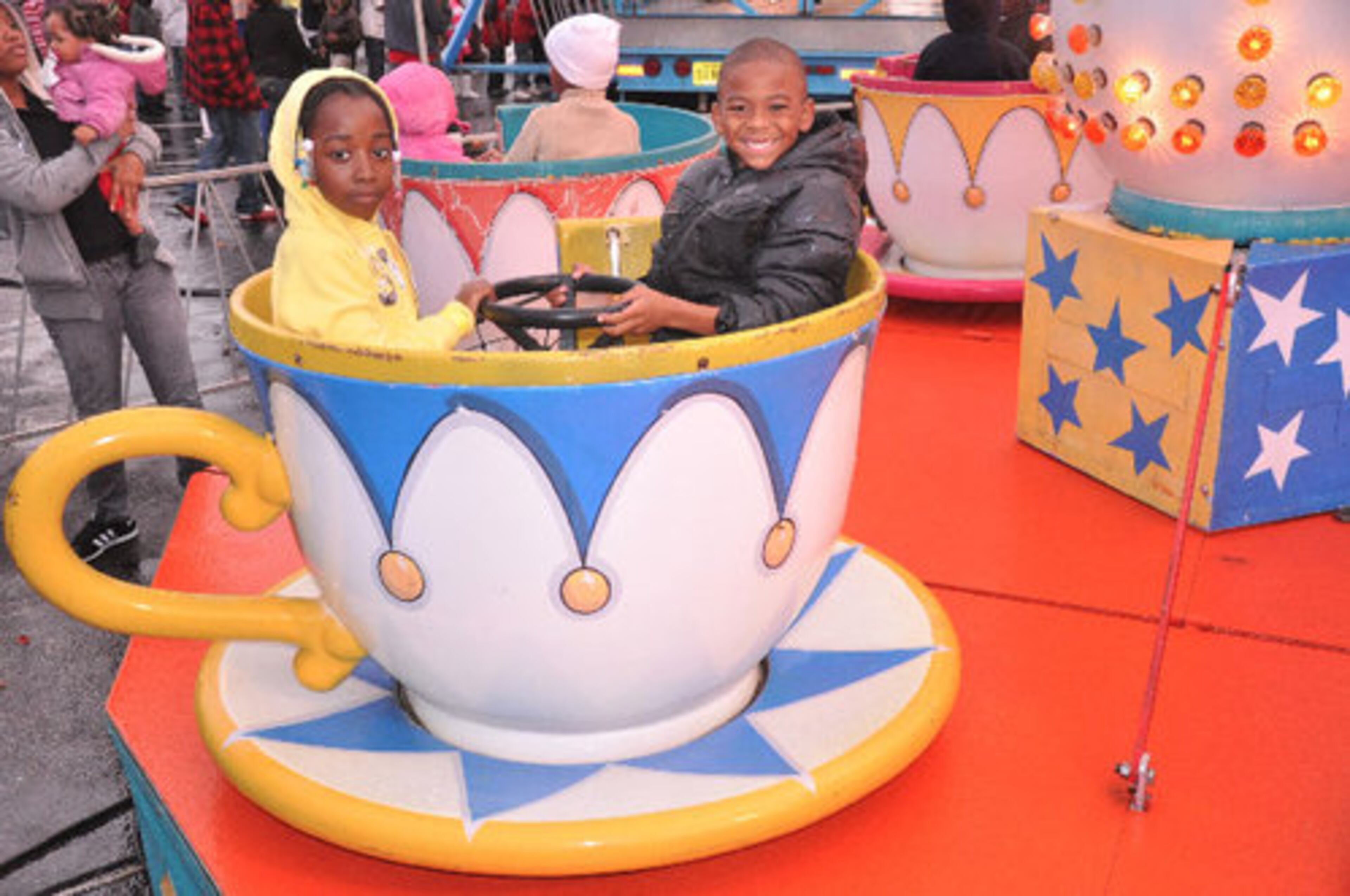 It's just like Disneyworld! Kids at the Thanksgiving Carnival take a spin in the tea cups.