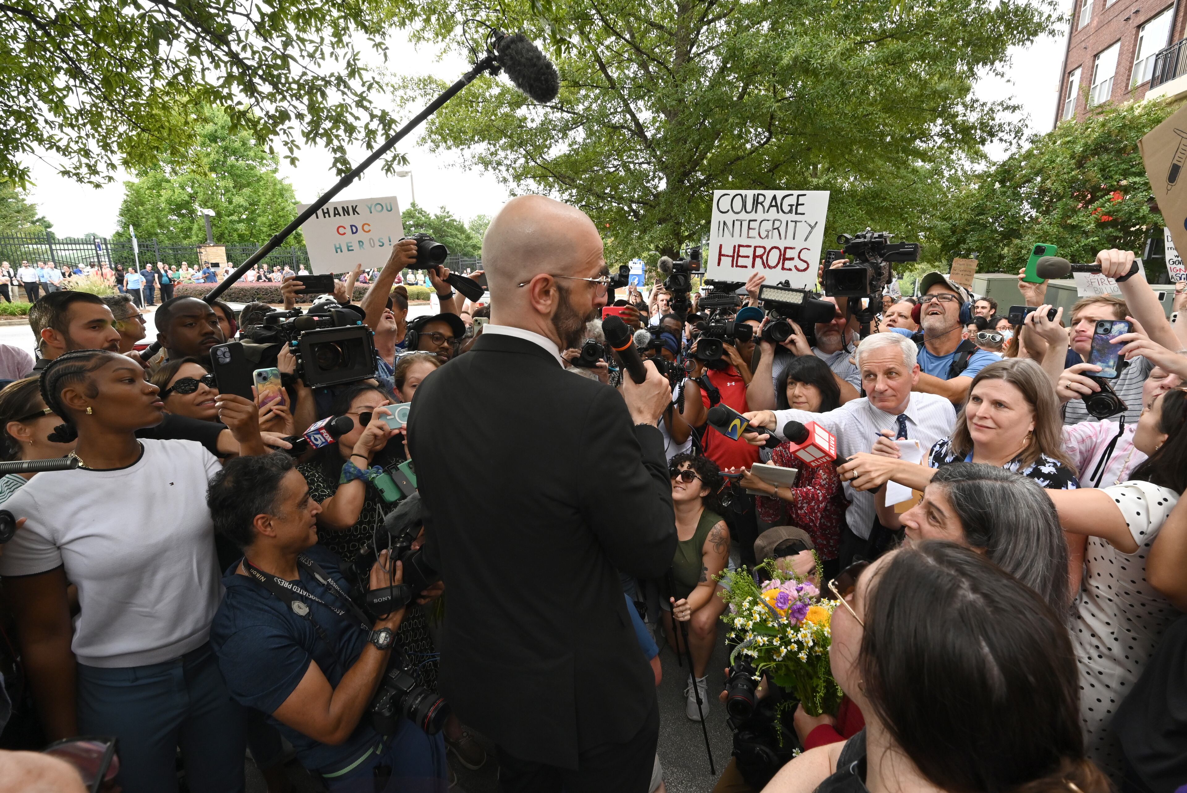Dr. Demetre Daskalakis, a top vaccine official, speaks to members of the press as CDC staff and supporters gather to rally for departing leaders outside the CDC headquarters, Thursday, August 28, 2025, in Atlanta. Top leaders who resigned their positions at the US Centers for Disease Control and Prevention after the ouster of the agency’s director were escorted out of the building Thursday morning. (Hyosub Shin / AJC)