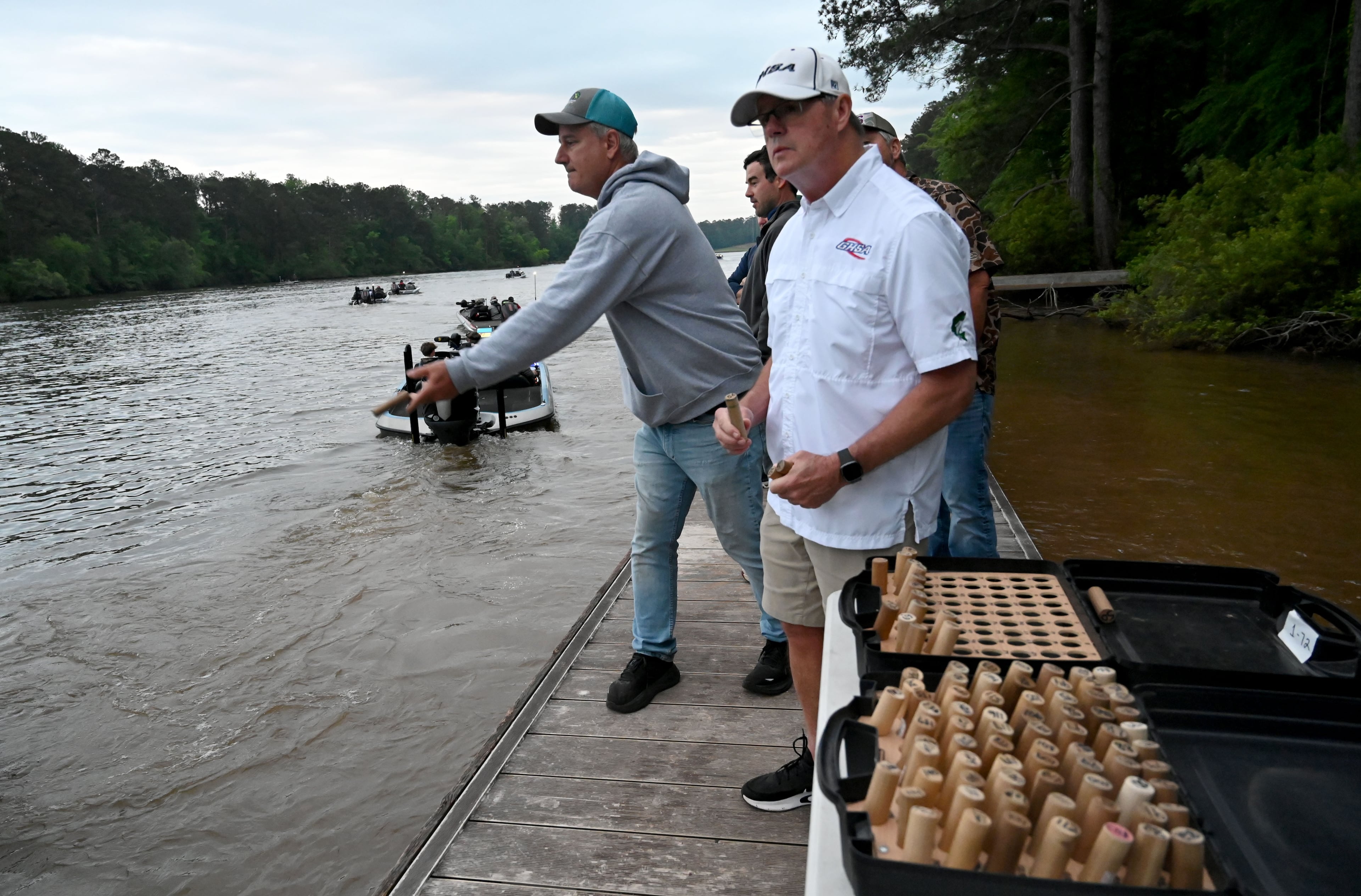 James Hines hands out boat floats as student anglers and their coaches head out on Lake Sinclair during the GHSA State Bass Fishing Championship on May 9, 2026. (Hyosub Shin/AJC)