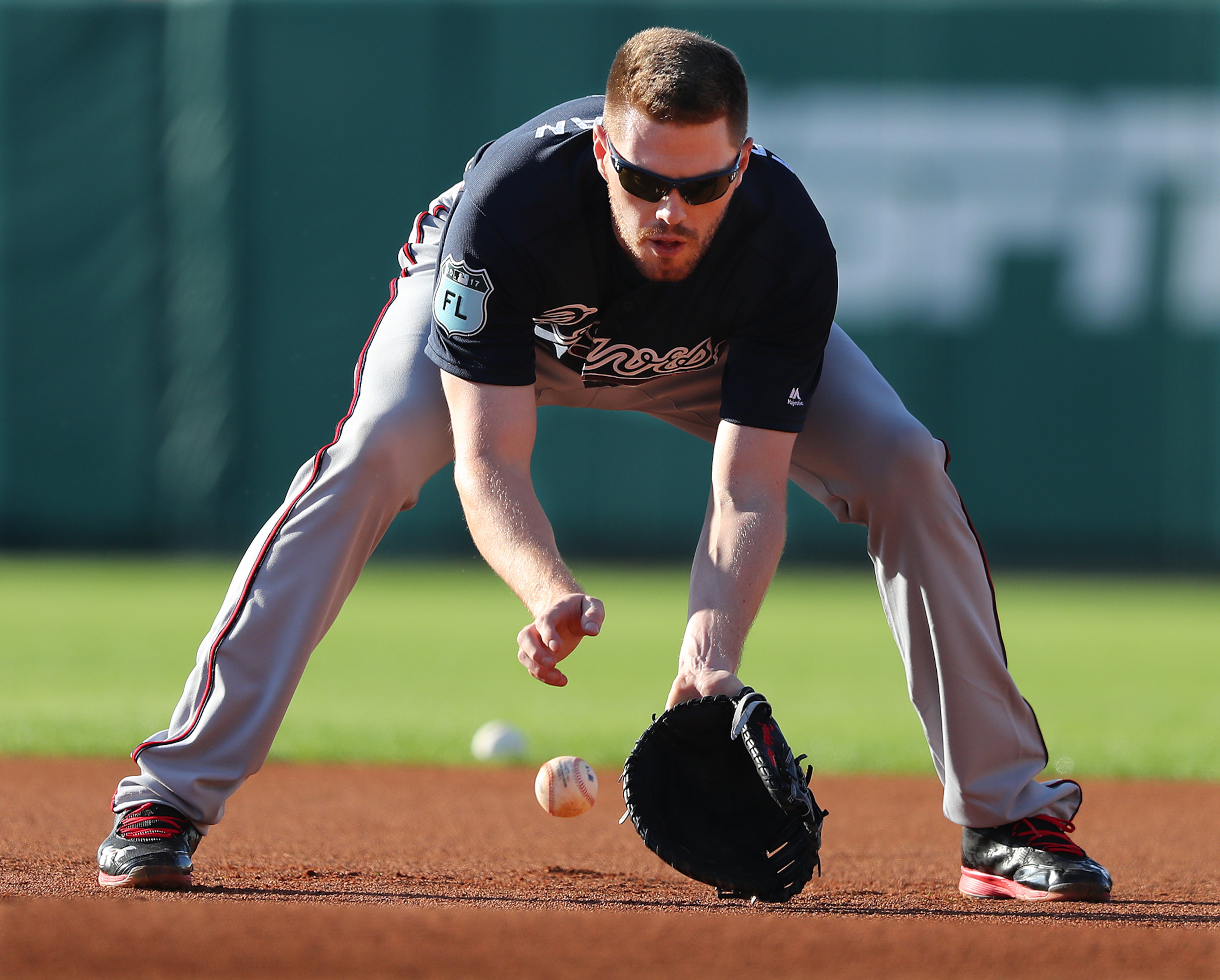 February 20, 2017, Lake Buena Vista, FL: Atlanta Braves Freddie Freeman fields a ground ball at first base during spring training at Champion Stadium on Monday Feb. 20, 2017, at the ESPN Wide World of Sports in Lake Buena Vista. Curtis Compton/ccompton@ajc.com