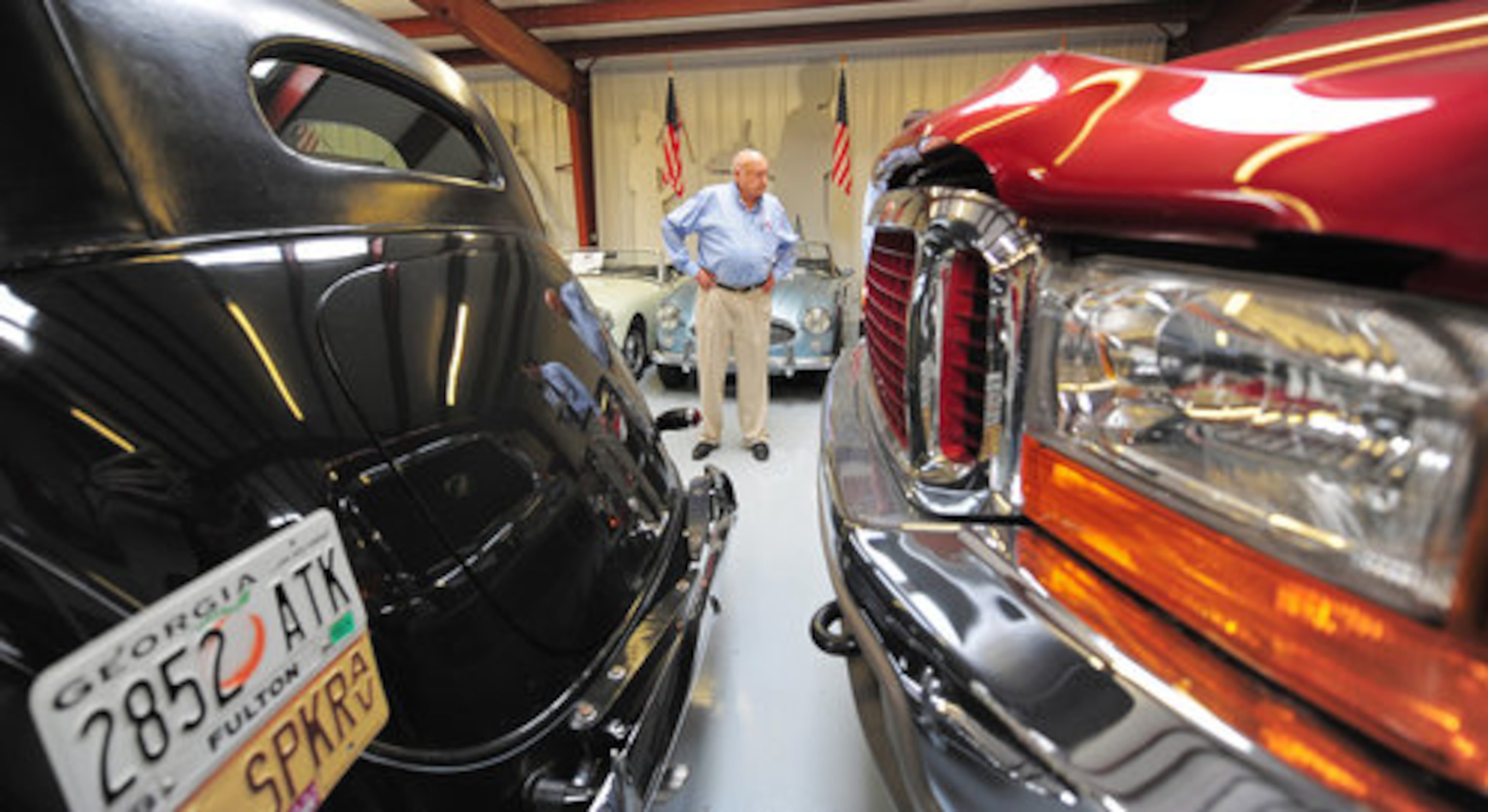 CATHY IS FRAMED by former Speaker of the House Dennis Hastert's 1937 Lincoln Continental (left) and a Ford Excursion stretch limousine.