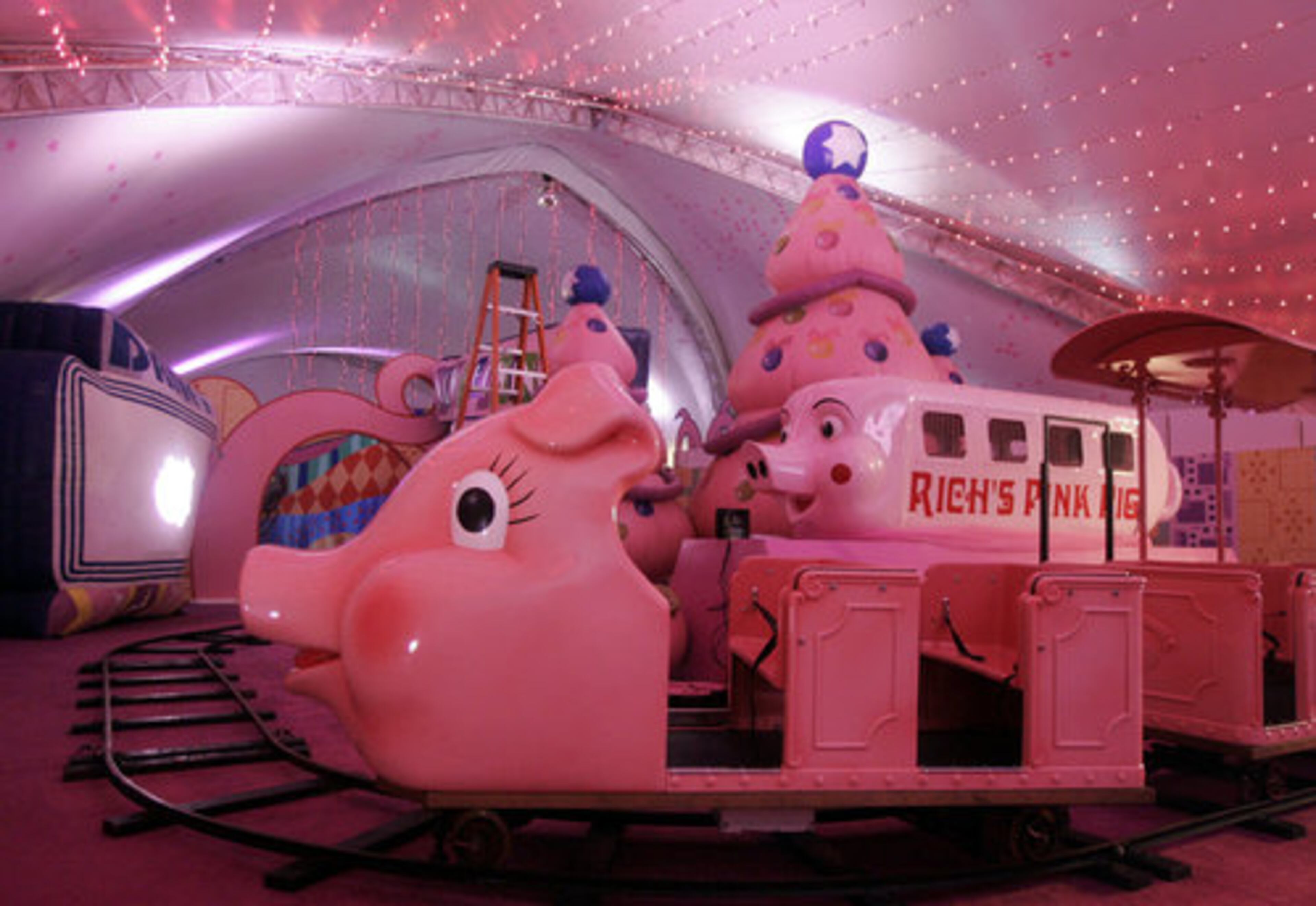 Workers spent Tuesday setting up the Macy's Pink Pig ride at Lenox Mall.