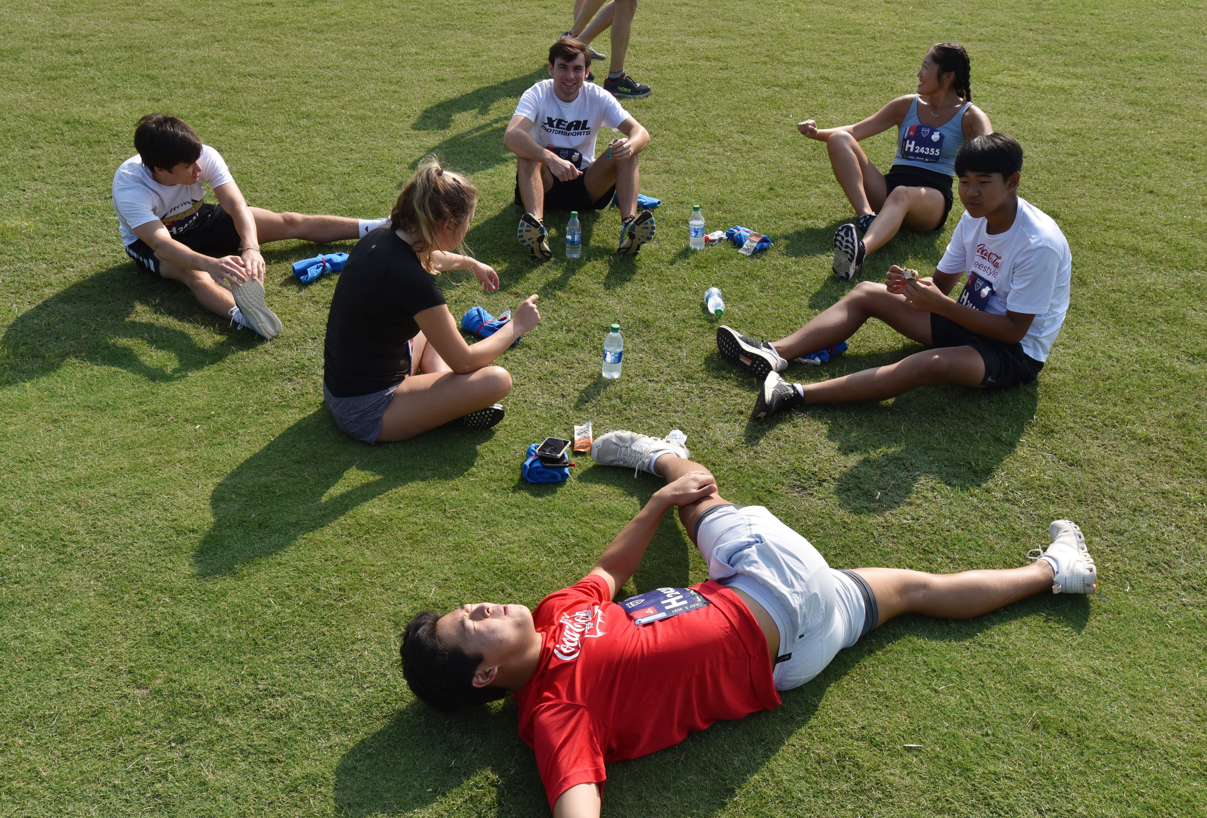 July 3, 2021 Atlanta - Nathan Chong (foreground) stretches after he finished his race during the first day of 2021 Atlanta Journal-Constitution Peachtree Road Race on Saturday, July 3, 2021. Hyosub Shin / Hyosub.Shin@ajc.com)