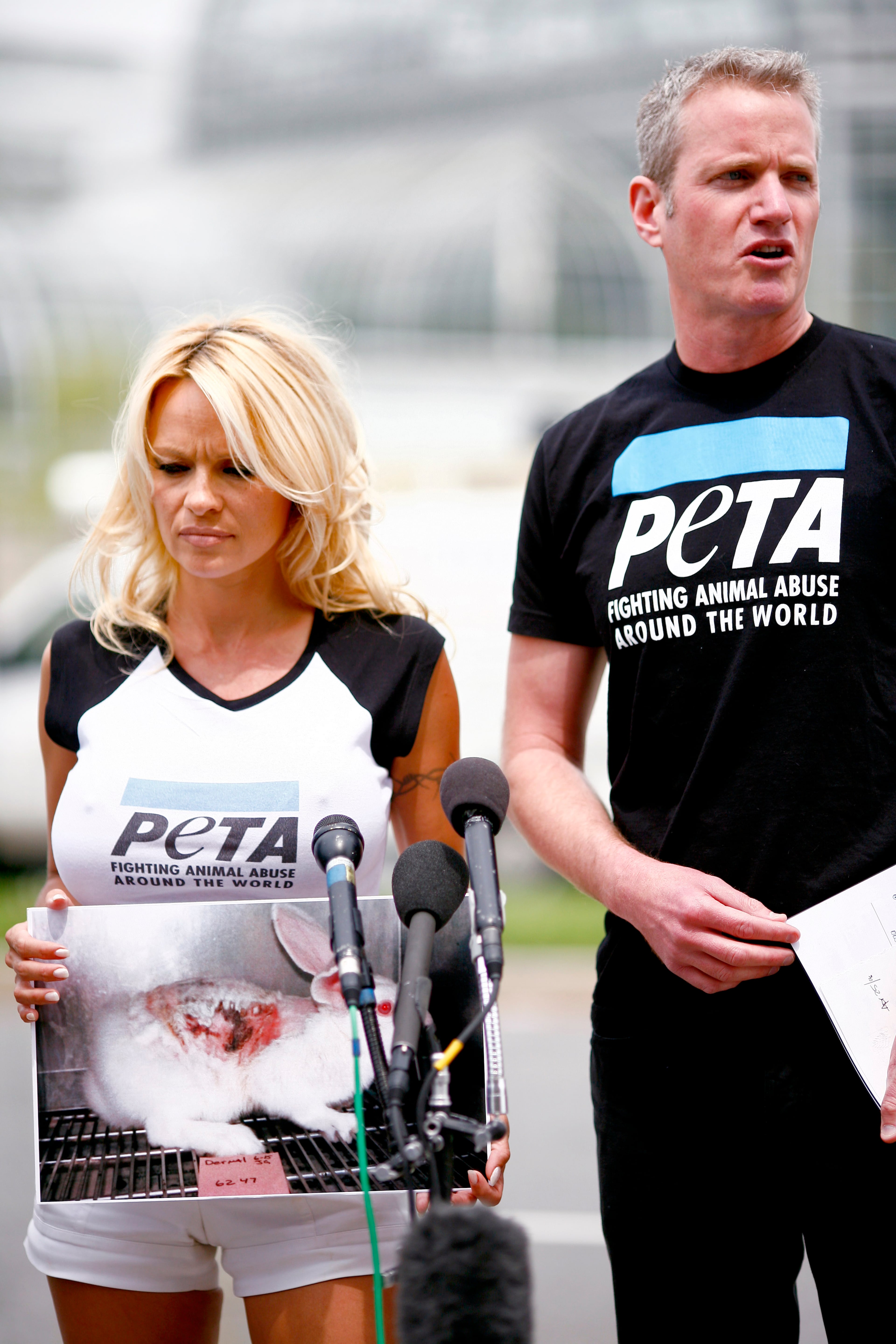 WASHINGTON - APRIL 25: Pamela Anderson, standing with PETA Senior Vice President Dan Mathews, makes an appearance on behalf of PETA in front of the Department of Health and Human Services April 25, 2008 in Washington, DC. Anderson appealed to officials at the department to replace outdated animal testing procedures with new technology. (Photo by Melissa Golden/Getty Images)