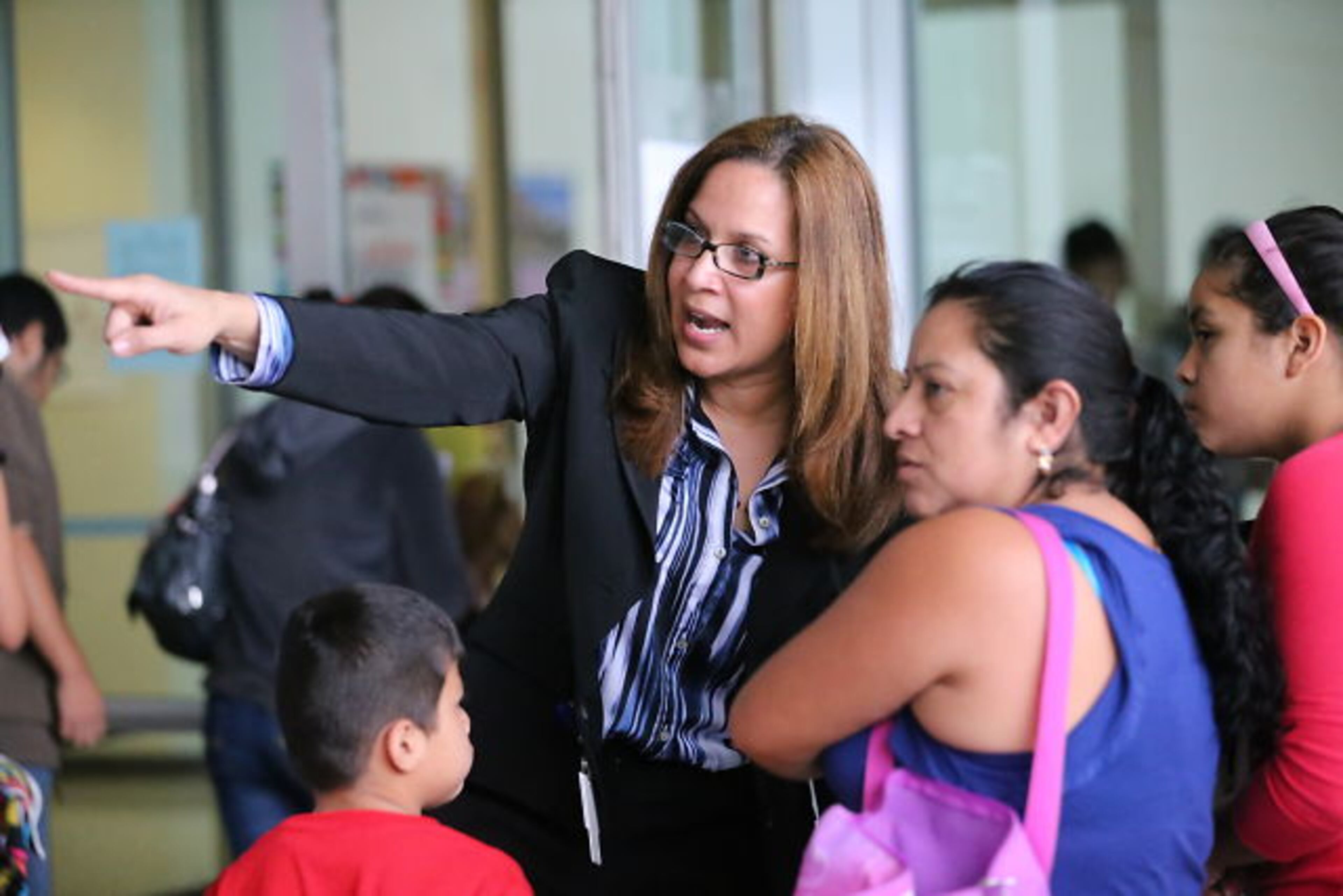 Hoping to get their children enrolled in DeKalb County Schools, immigrant families spent Thursday night and early Friday lined up with their children outside district headquarters.