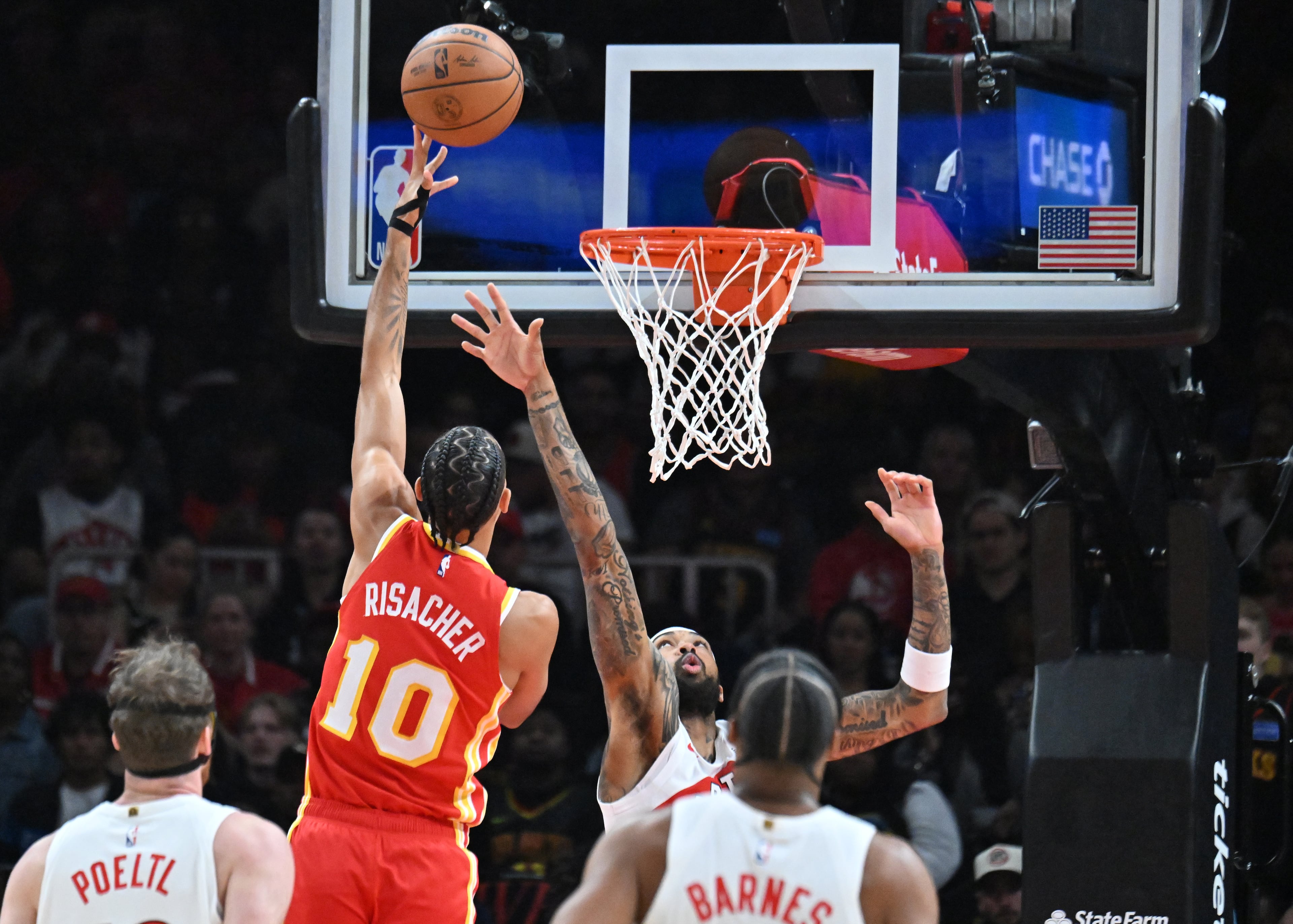 Atlanta Hawks forward Zaccharie Risacher (10) goes to the basket for the shot during the first half in the home opener at State Farm Arena, Thursday, October 22, 2025, in Atlanta. (Hyosub Shin / AJC)