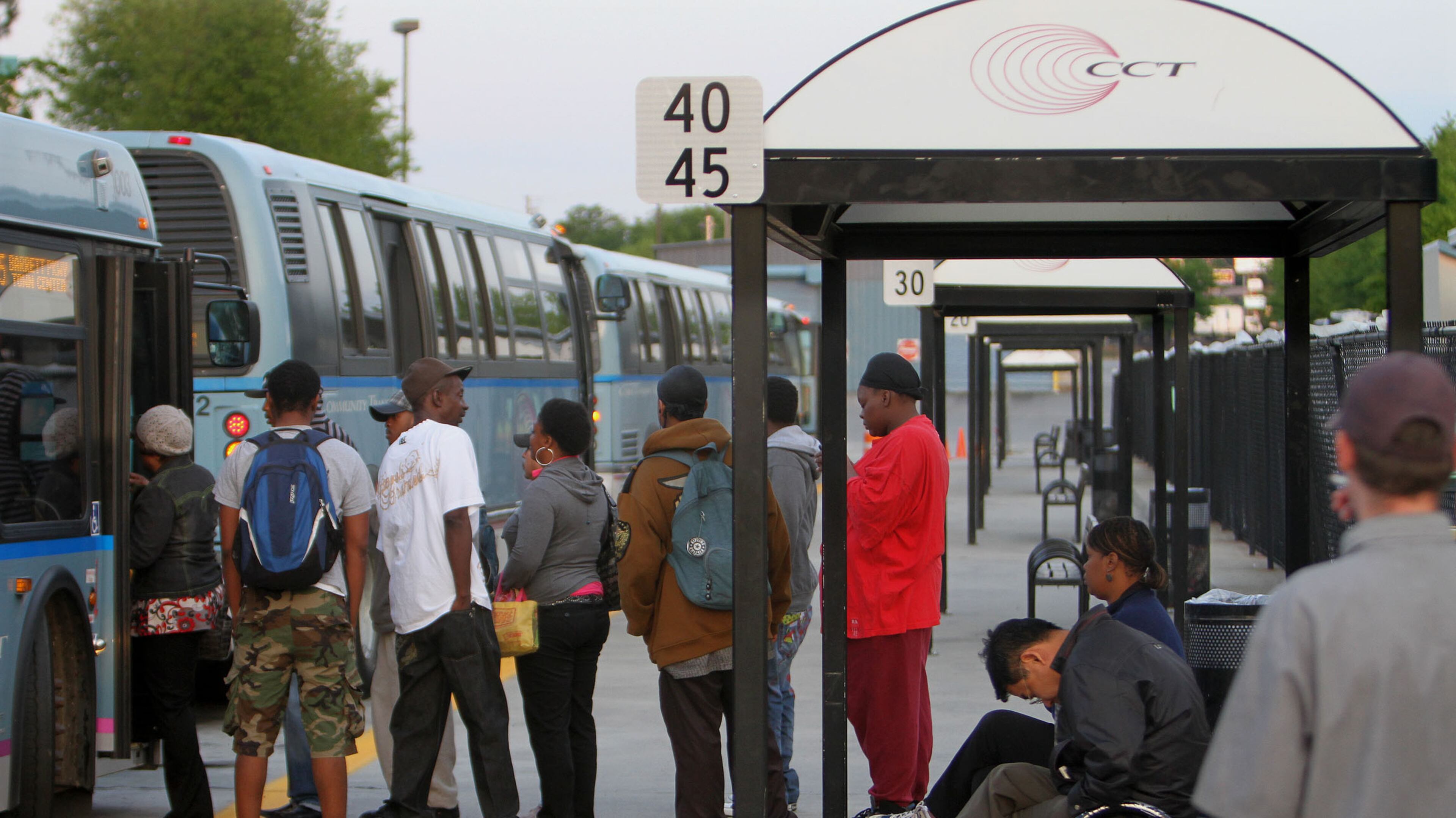 Morning rush hour commuters gather at the Cobb Community Transit in Marietta on Tuesday.
