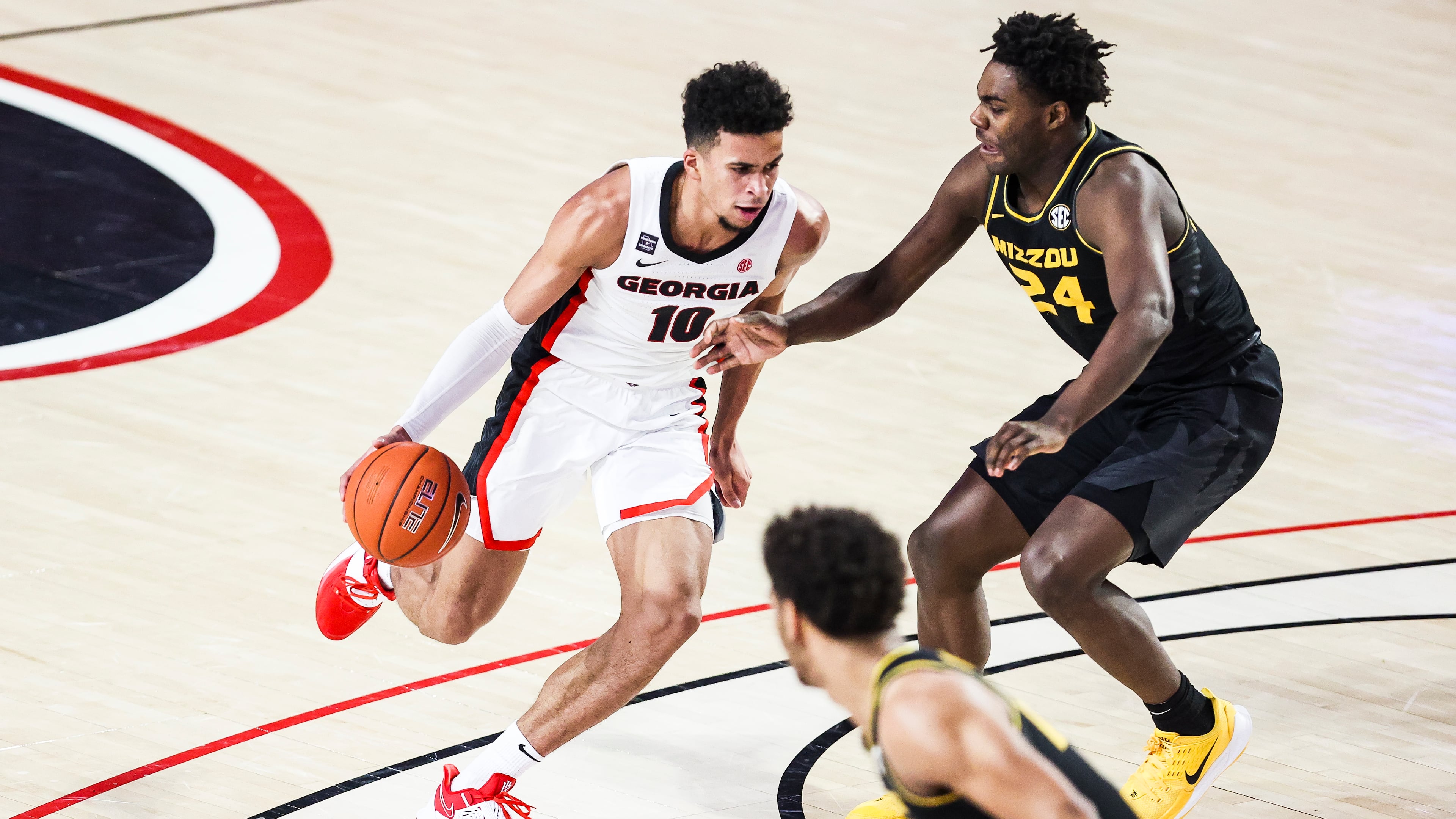 Georgia basketball player Toumani Camara (10) drives on Missouri's Kobe Brown during the Bulldogs 80-70 win over the Np. 20 Tigers Feb. 16, 2021, at Stegeman Coliseum in Athens. (Photo by Tony Walsh/UGA Athletics)