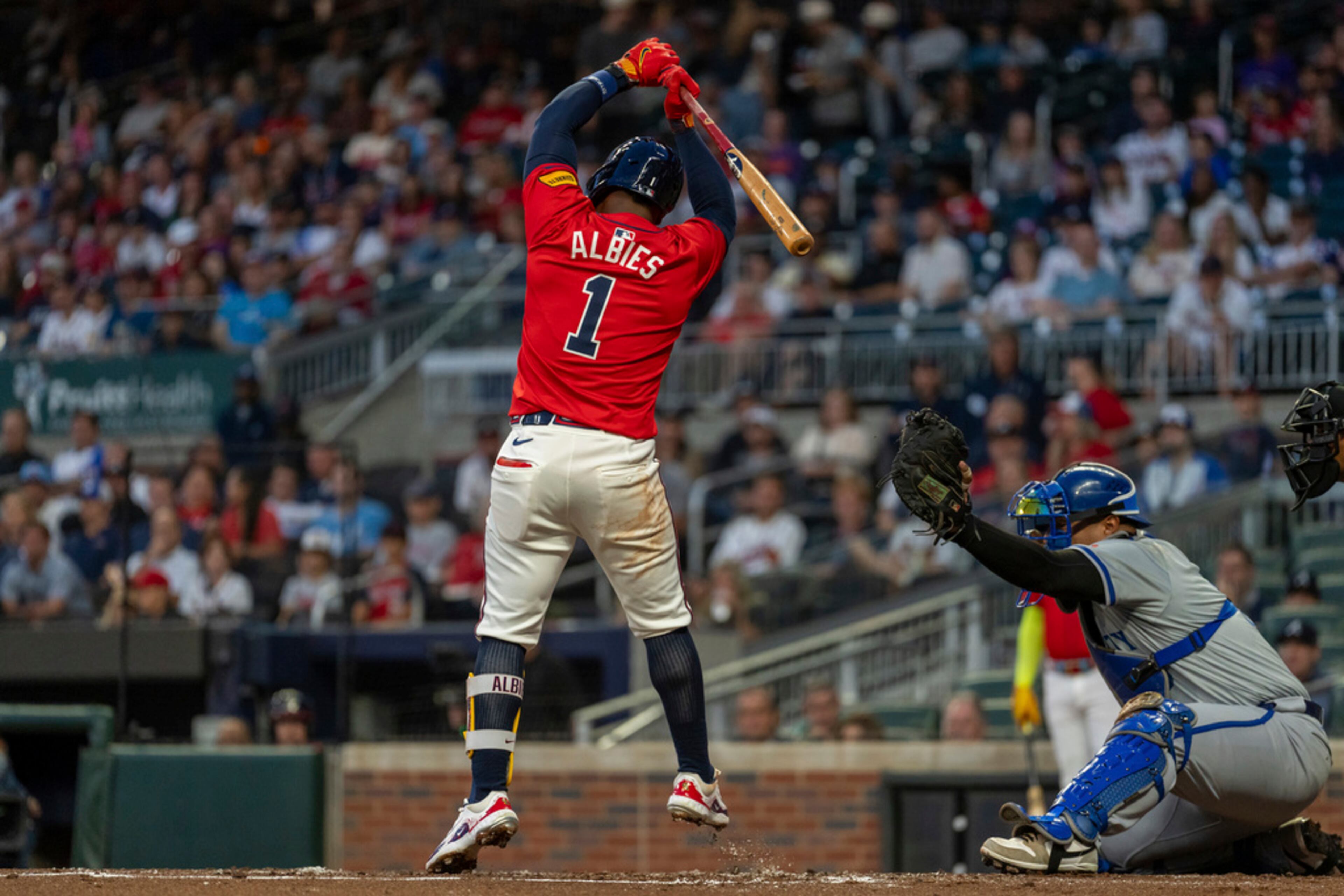 Kansas City Royals catcher Salvador Perez, right, catches the pitch as Atlanta Braves' Ozzie Albies jumps out of the way to avoid being hit in the first inning of a baseball game, Friday, Sept. 27, 2024, in Atlanta. (AP Photo/Jason Allen)