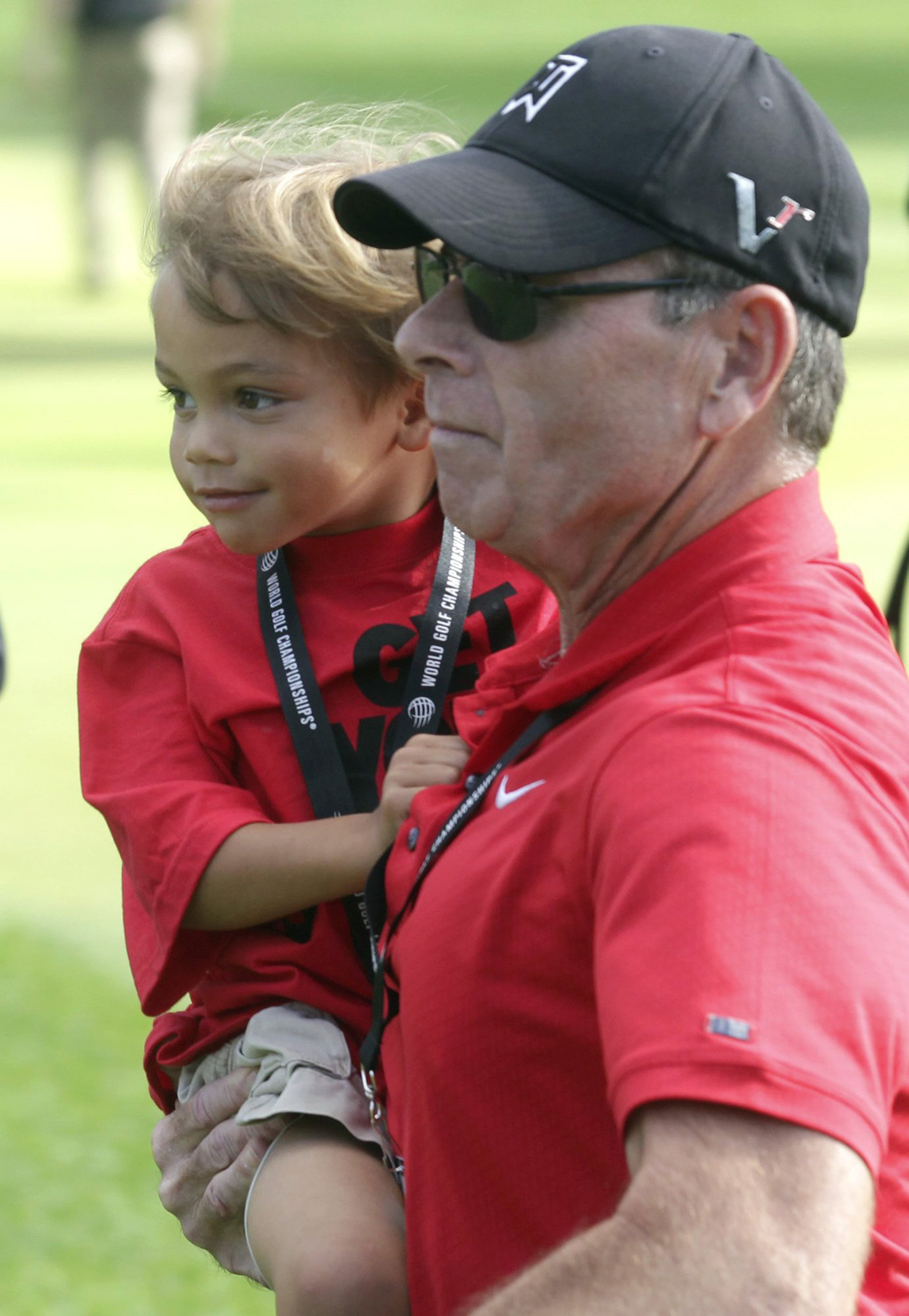 Tiger Wood's son, Charlie, is carried across the green on the 18th hole after the final round of the WGC-Bridgestone Invitational golf tournament in Akron, Ohio, August 4, 2013. (REUTERS/Matt Sullivan)