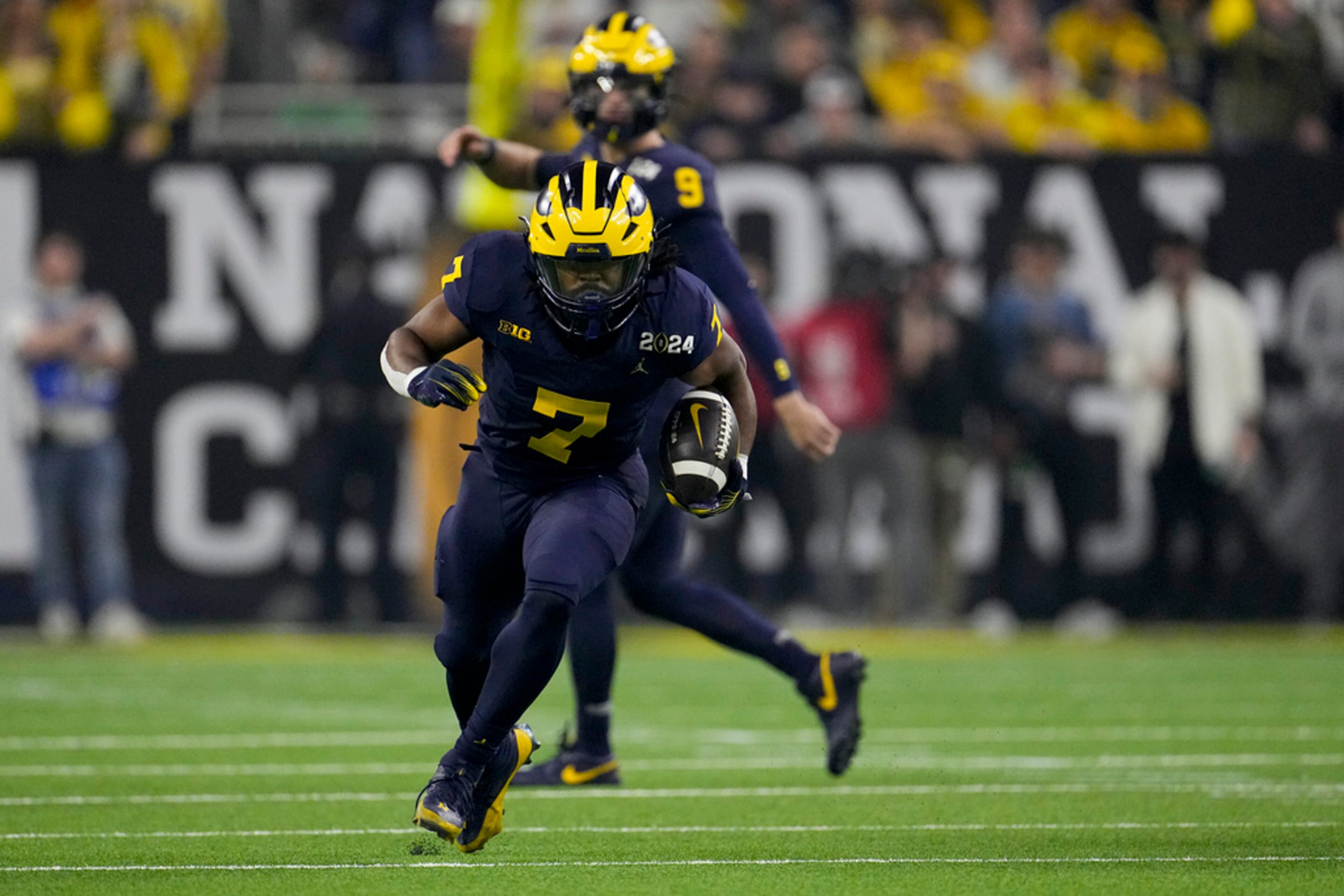 Michigan running back Donovan Edwards runs for a touchdown against Washington during the first half of the national championship NCAA College Football Playoff game Monday, Jan. 8, 2024, in Houston. (AP Photo/David J. Phillip)