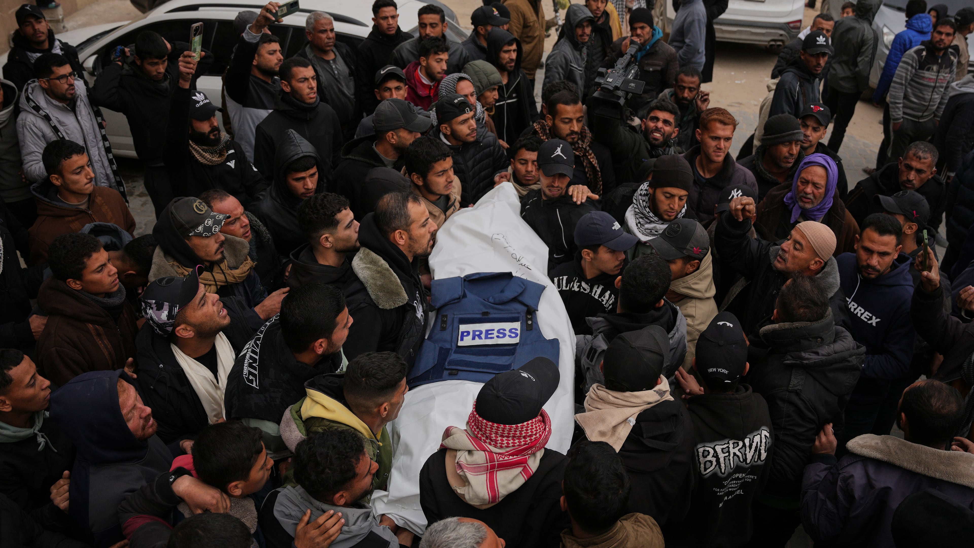 Mourners carry the body of Anas Ghoneim, one of the three Palestinian journalists who were killed in an Israeli strike on an Egyptian committee's vehicle, during his funeral in Khan Younis, southern Gaza Strip, Thursday, Jan. 22, 2026. (AP Photo/Abdel Kareem Hana)