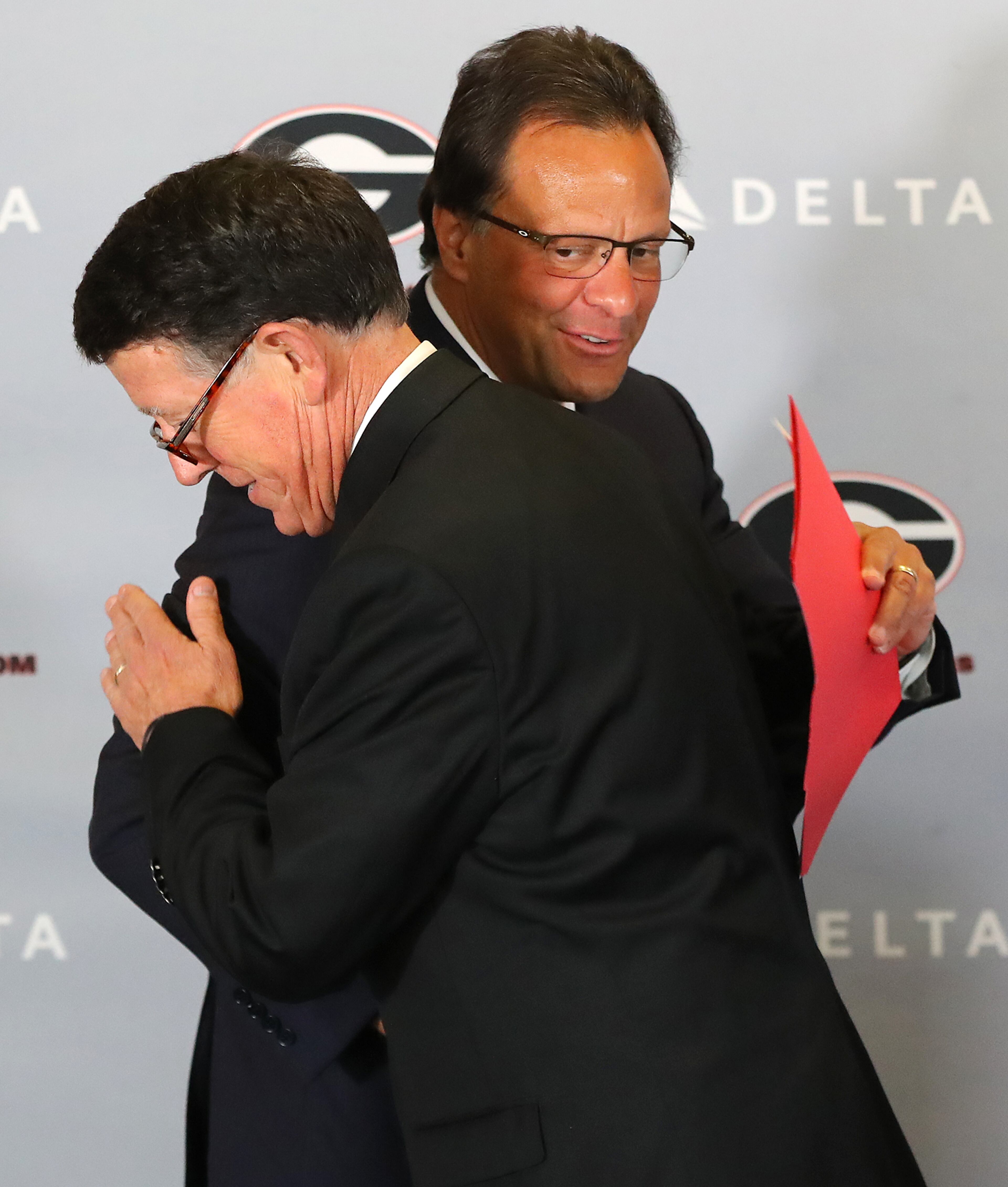 March 16, 2018 Athens: Georgia athletics director Greg McGarity (left) gets a hug from Tom Crean while he is introduced as the new men's basketball head coach at the University of Georgia on Friday, March 16, 2018, at Stegeman Coliseum in Athens. Crean compiled a 356-231 record in 18 seasons at Marquette and Indiana from 1999-2017. Curtis Compton/ccompton@ajc.com