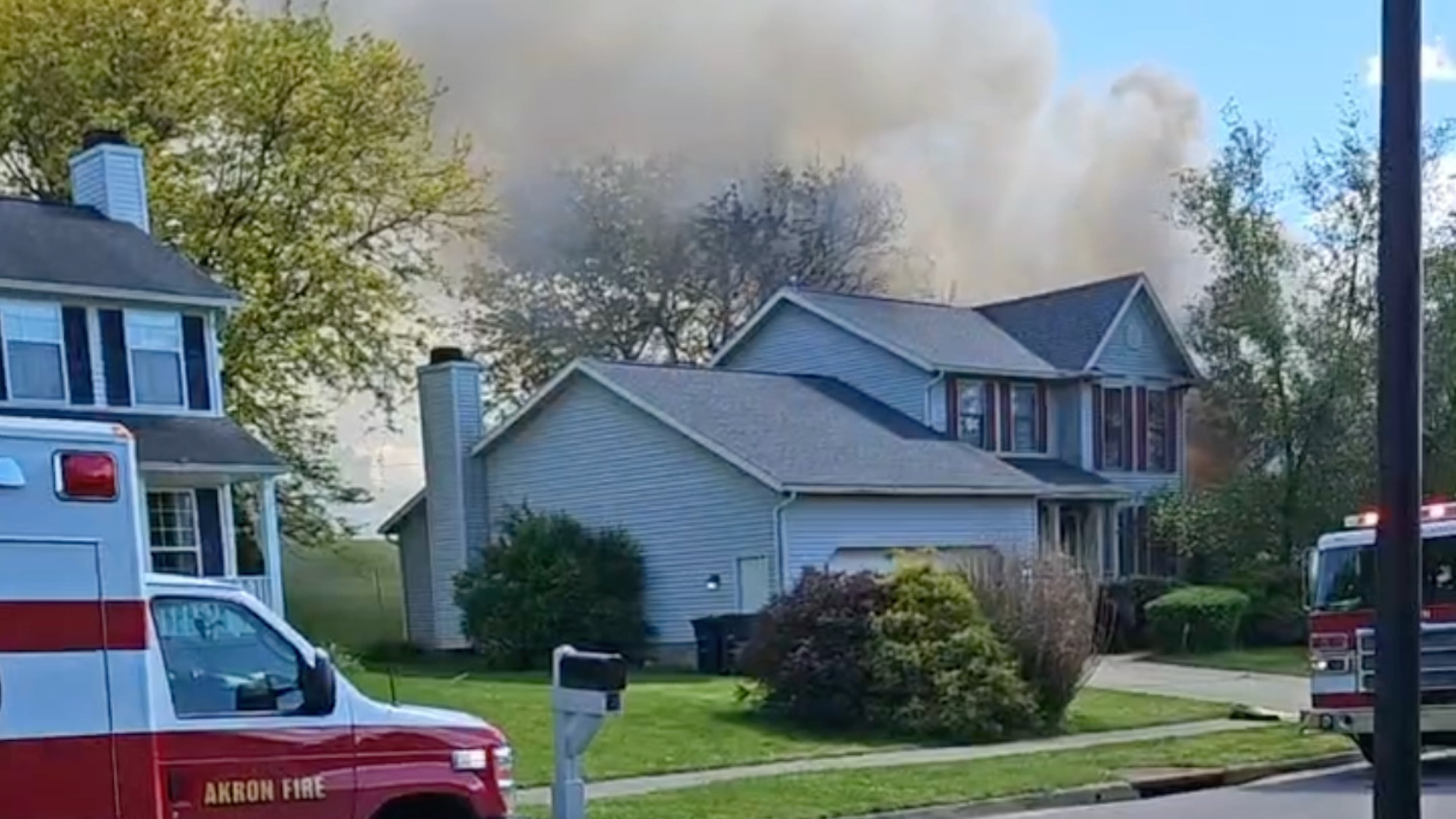 This image taken from video provided by Thomas A. Tatum shows smoke rising after a plane crashed into a house in Akron, Ohio, on Thursday, May 14, 2026. (Thomas A. Tatum via AP)