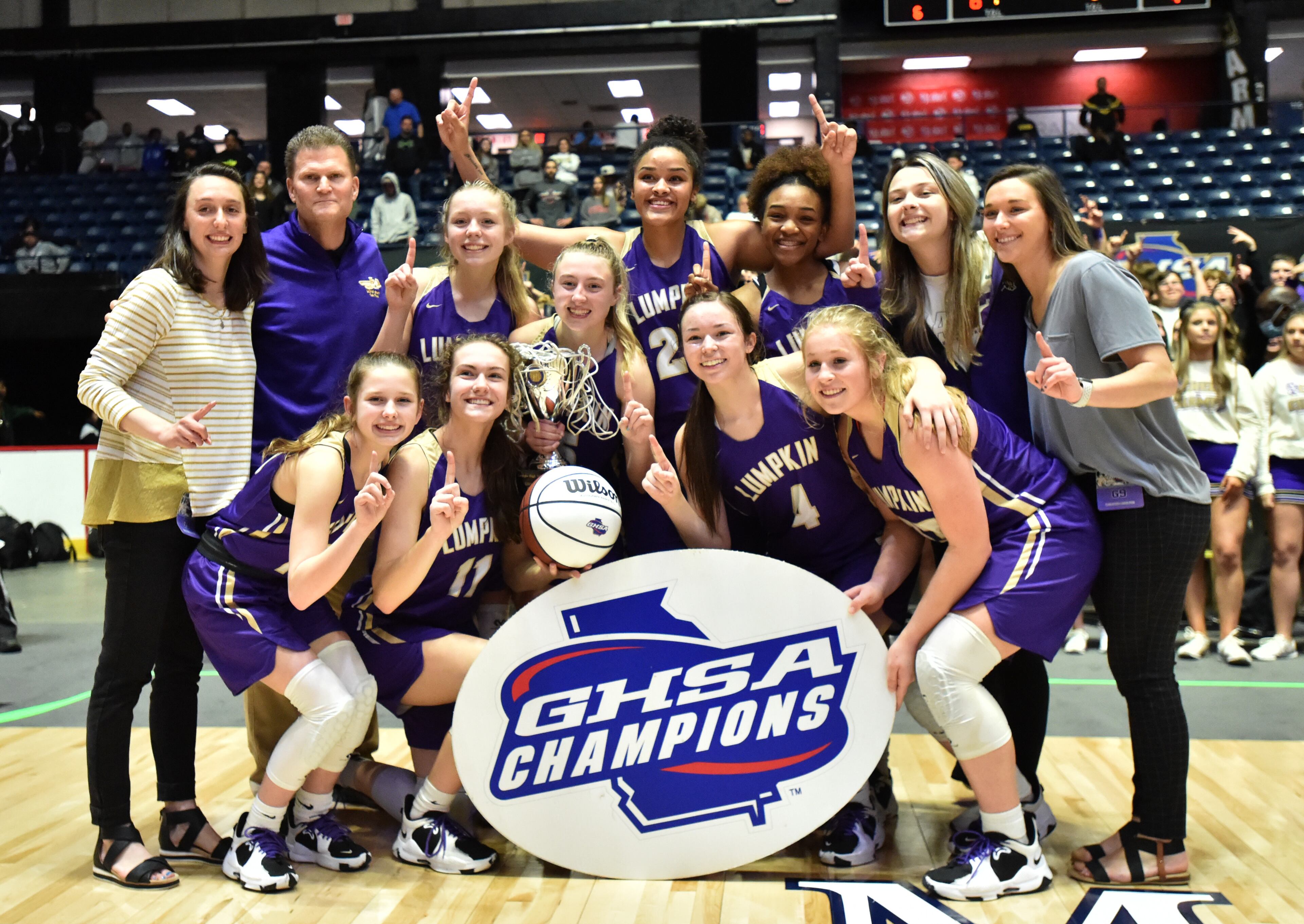 March 11, 2022 Macon - Lumpkin County's head coach David Dowse and players celebrate their victory over Greater Atlanta Christian during the 2022 GHSA State Basketball Class AAA Girls Championship game at the Macon Centreplex in Macon on Friday, March 11, 2022. (Hyosub Shin / Hyosub.Shin@ajc.com)