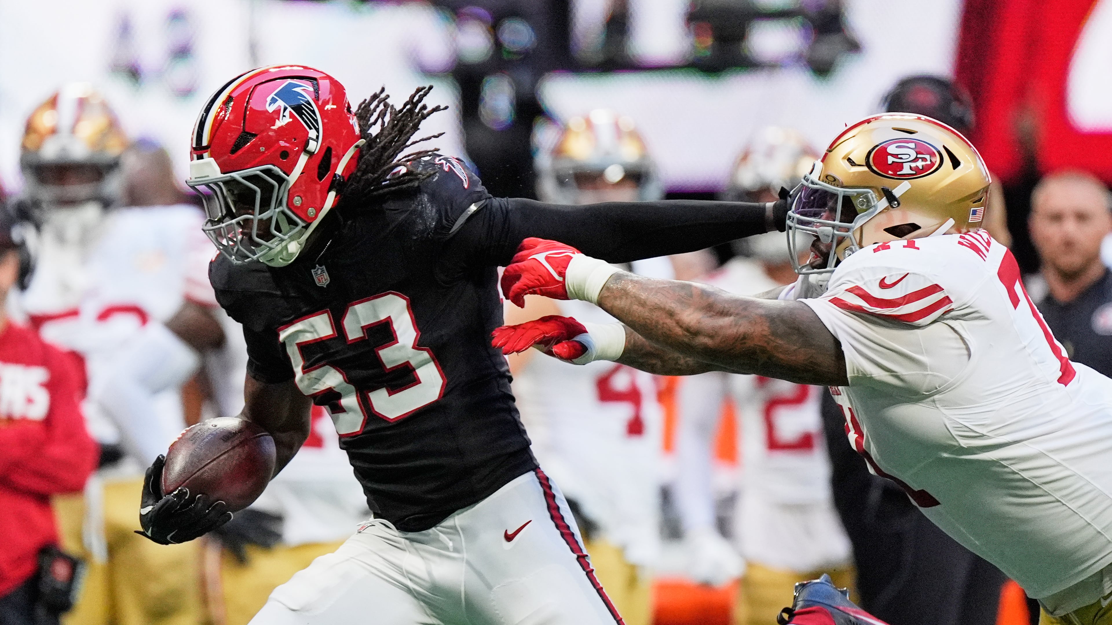 Atlanta Falcons linebacker Kendal Daniels (53) returns an interception as San Francisco 49ers offensive tackle Trent Williams, right, makes the stop during the second half of an NFL football game in Atlanta, Sunday, Oct. 25, 2026. (AP Photo/Mike Stewart)