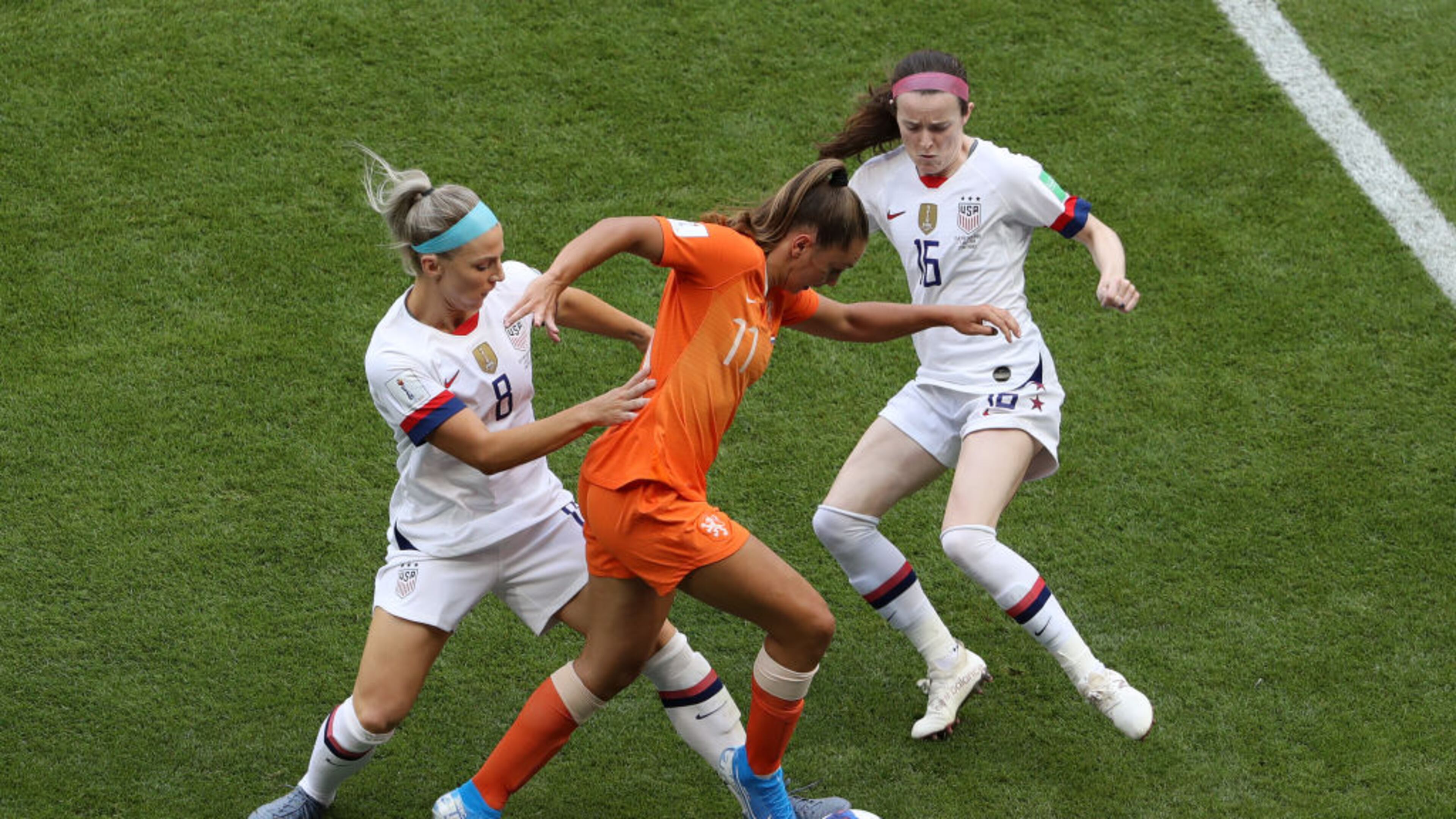 LYON, FRANCE - JULY 07: Lieke Martens of the Netherlands is tackled by Julie Ertz and Rose Lavelle of the USA during the 2019 FIFA Women's World Cup France Final match between The United States of America and The Netherlands at Stade de Lyon on July 07, 2019 in Lyon, France. (Photo by Robert Cianflone/Getty Images)