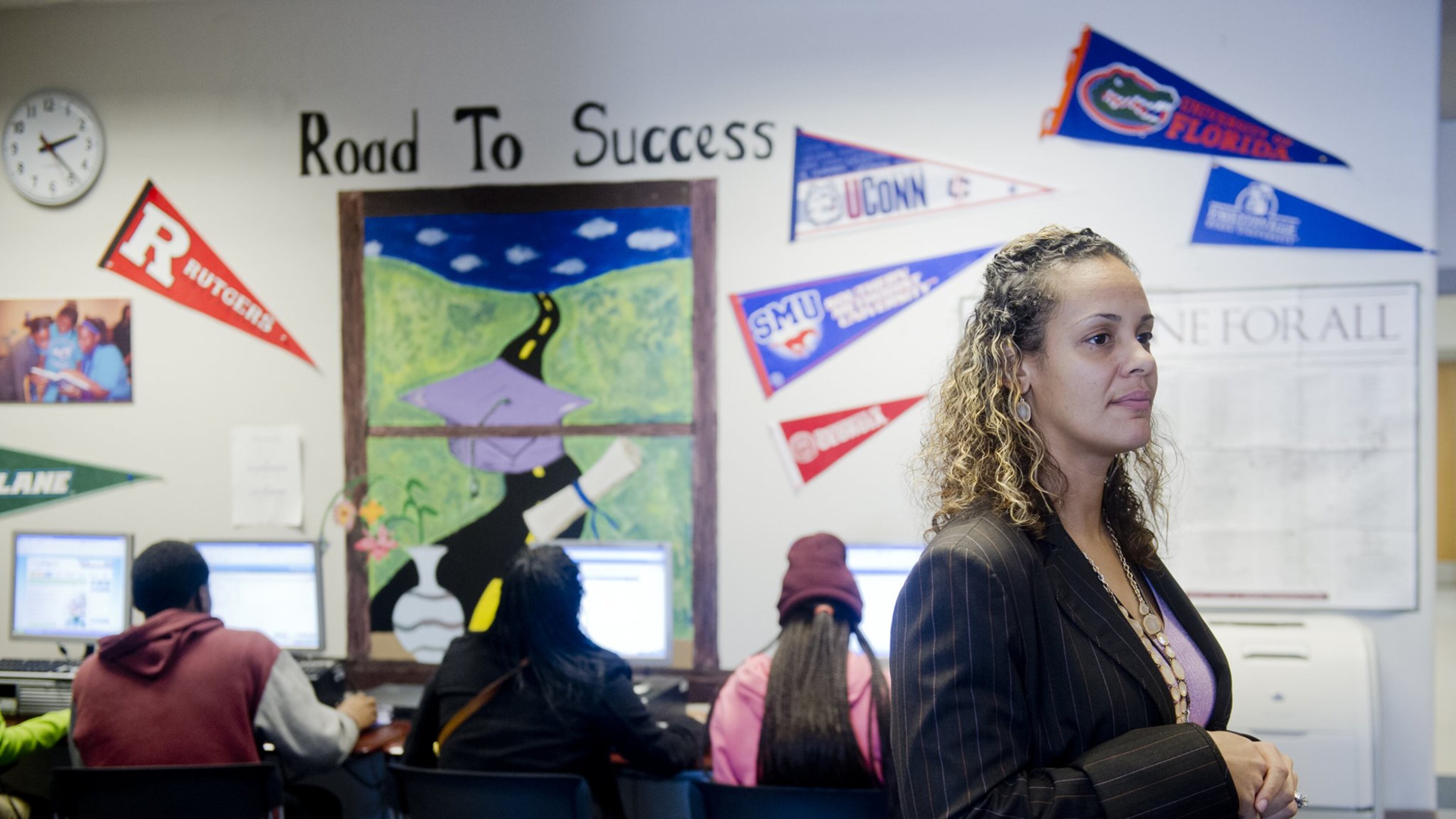 Cinzia Thomas (right) walks around her office at the South Atlanta Educational Complex making sure her students have everything they need to fill out college applications, scholarship applications, online classes and test registrations on Tuesday, December 17, 2013. South Atlanta High’s School of Health and Medical Science, which is one of three schools at the educational complex, graduation rates jumped 10 percentage points thanks in part to Thomas, who is a graduation coach for all three schools.