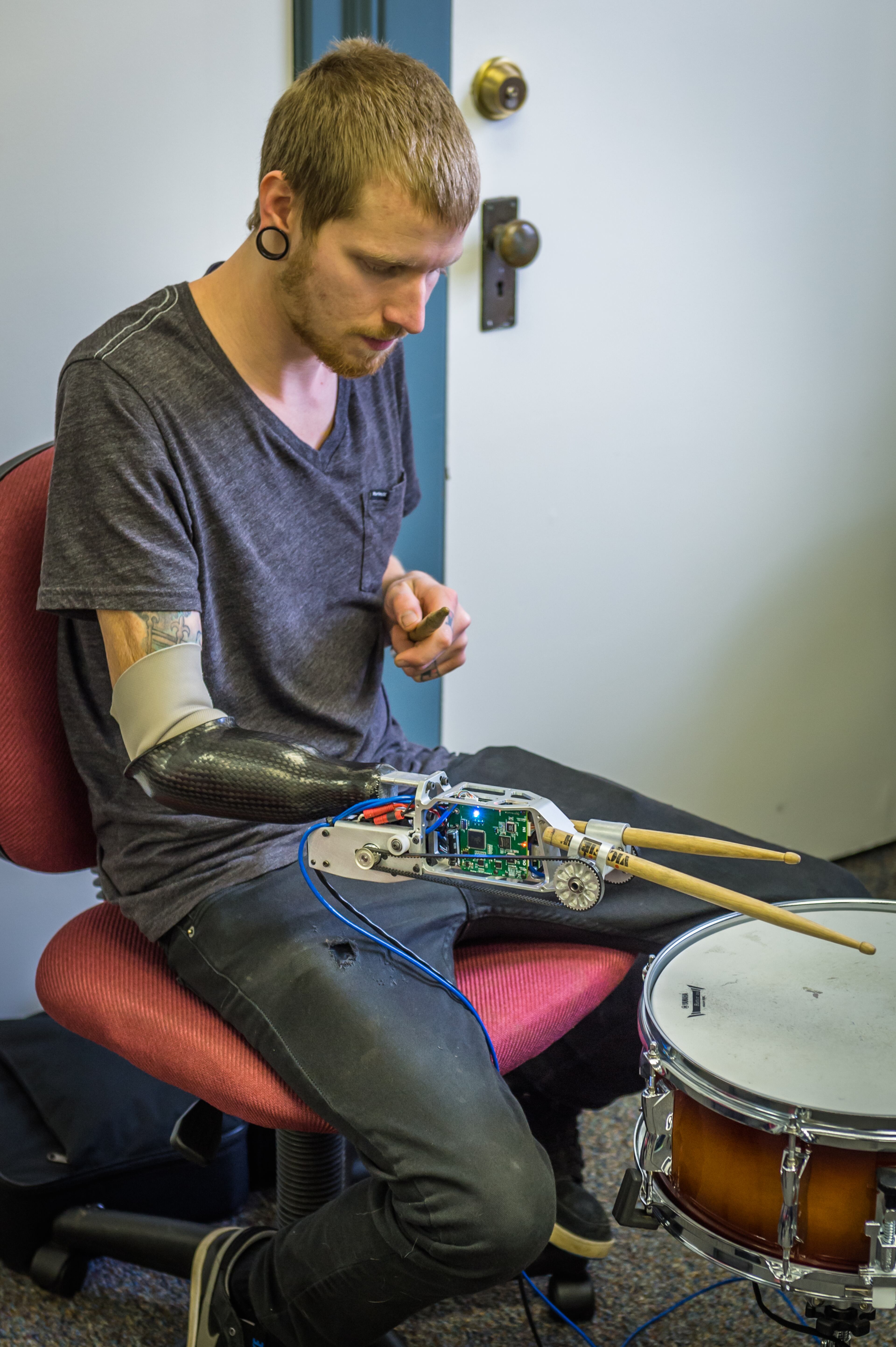 The Meka robot arm uses tiny belt-driven electric motors. When in use, it is connected through a USB cable to its digital brain in a nearby laptop.