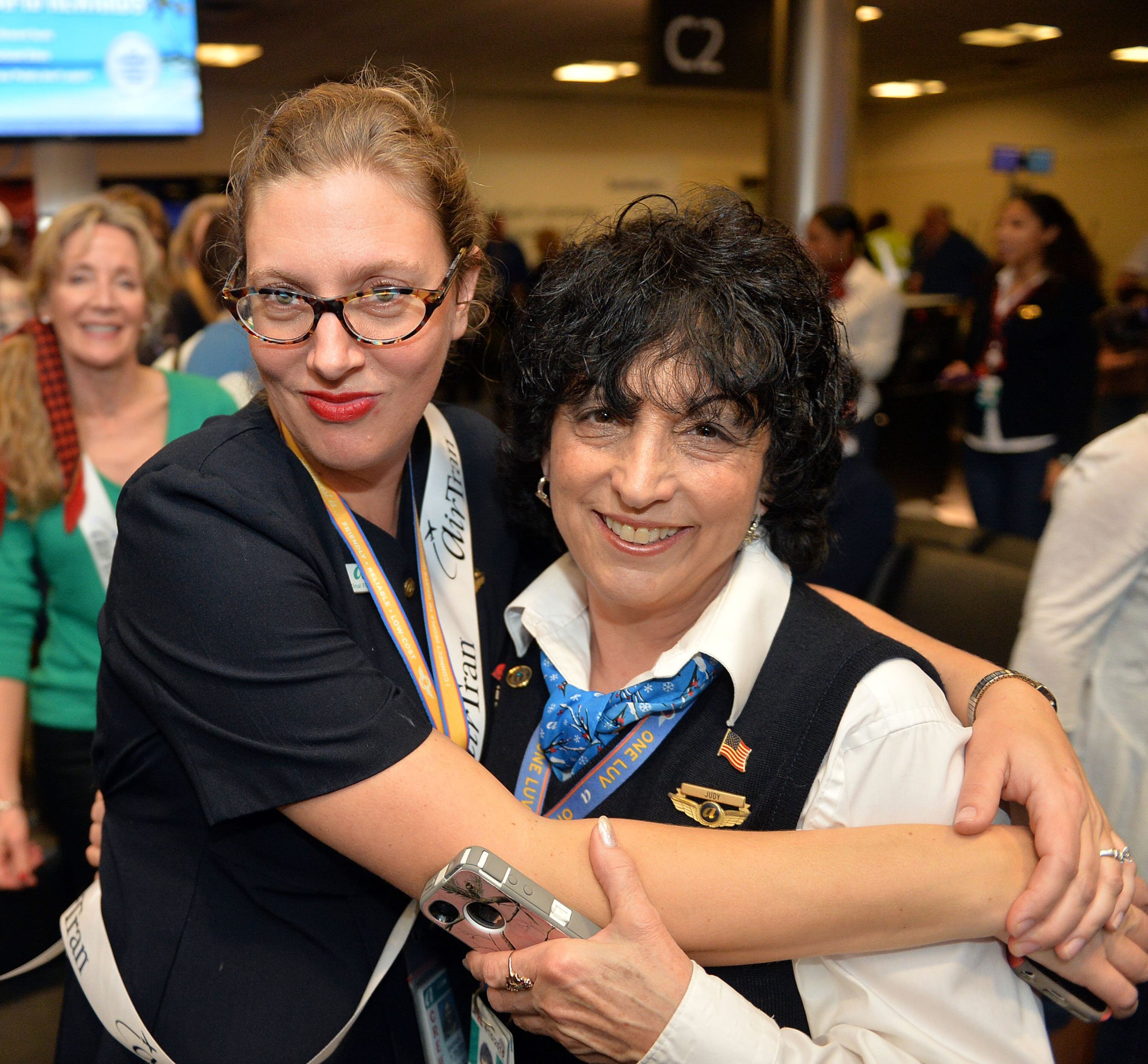 Flight attendants Sarah Wilson and Judy Davis share a hug during the party. Hundreds of Southwest Airlines and former AirTran Airways employees gathered at Concourse C, gates 1, 2 and 3 to celebrate the departure of AirTran’s final flight to Tampa, at Hartsfield-Jackson International Airport, Sunday, December 28, 2014. Southwest CEO Gary Kelly and executives Bob Jordan and Jack Smith gave remarks during the program. The full flight was waved off by employees that gathered on the tarmac as crash trucks from Atlanta Fire Rescue gave a final water cannon salute as the plane departed. KENT D. JOHNSON/KDJOHNSON@AJC.COM