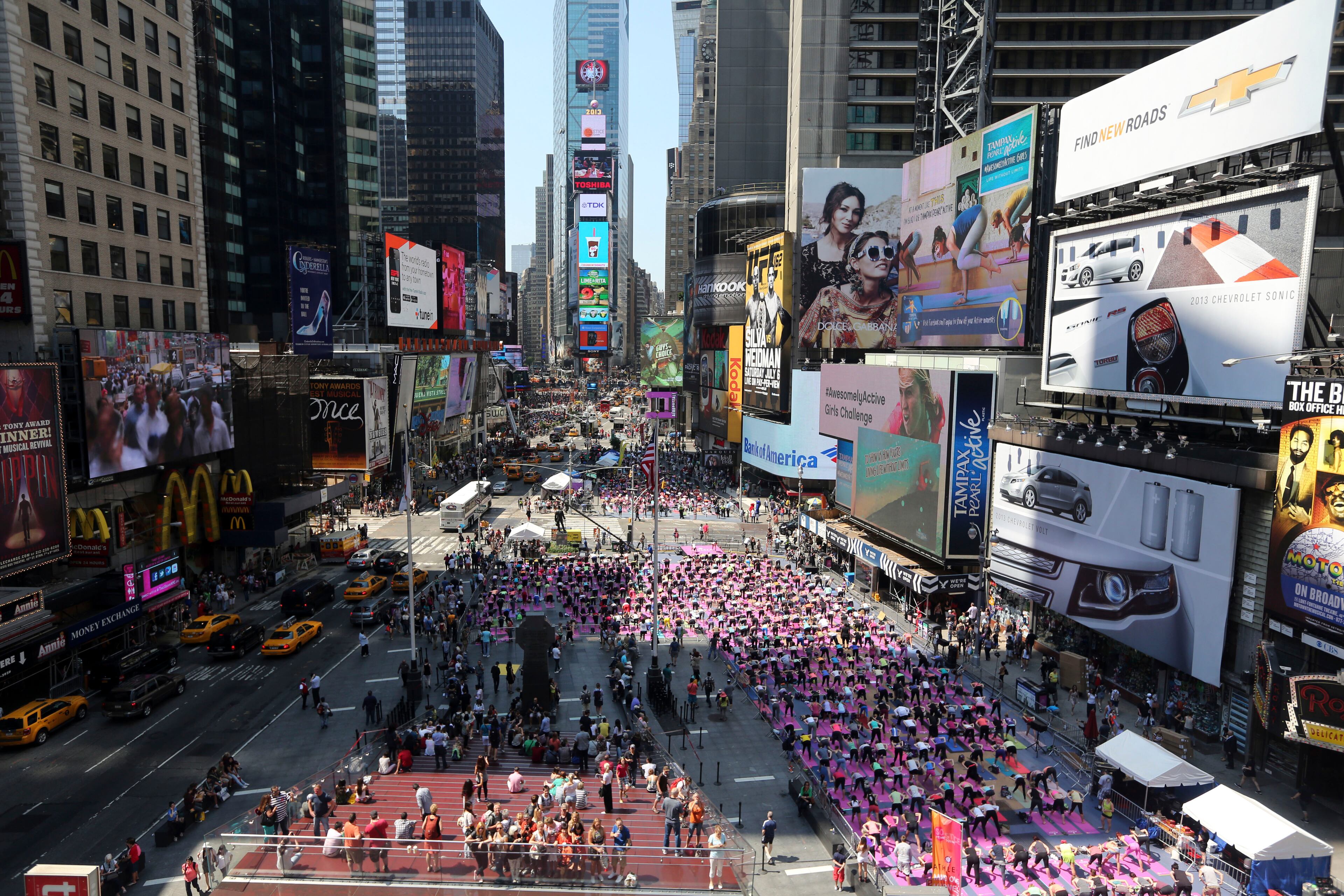 People practice yoga in New York's Times Square, Friday, June 21, 2013. Yoga enthusiast marked the longest day of the year with five free "Mind Over Madness" yoga classes during the11th annual Solstice in Times Square. (AP Photo/Mary Altaffer)
