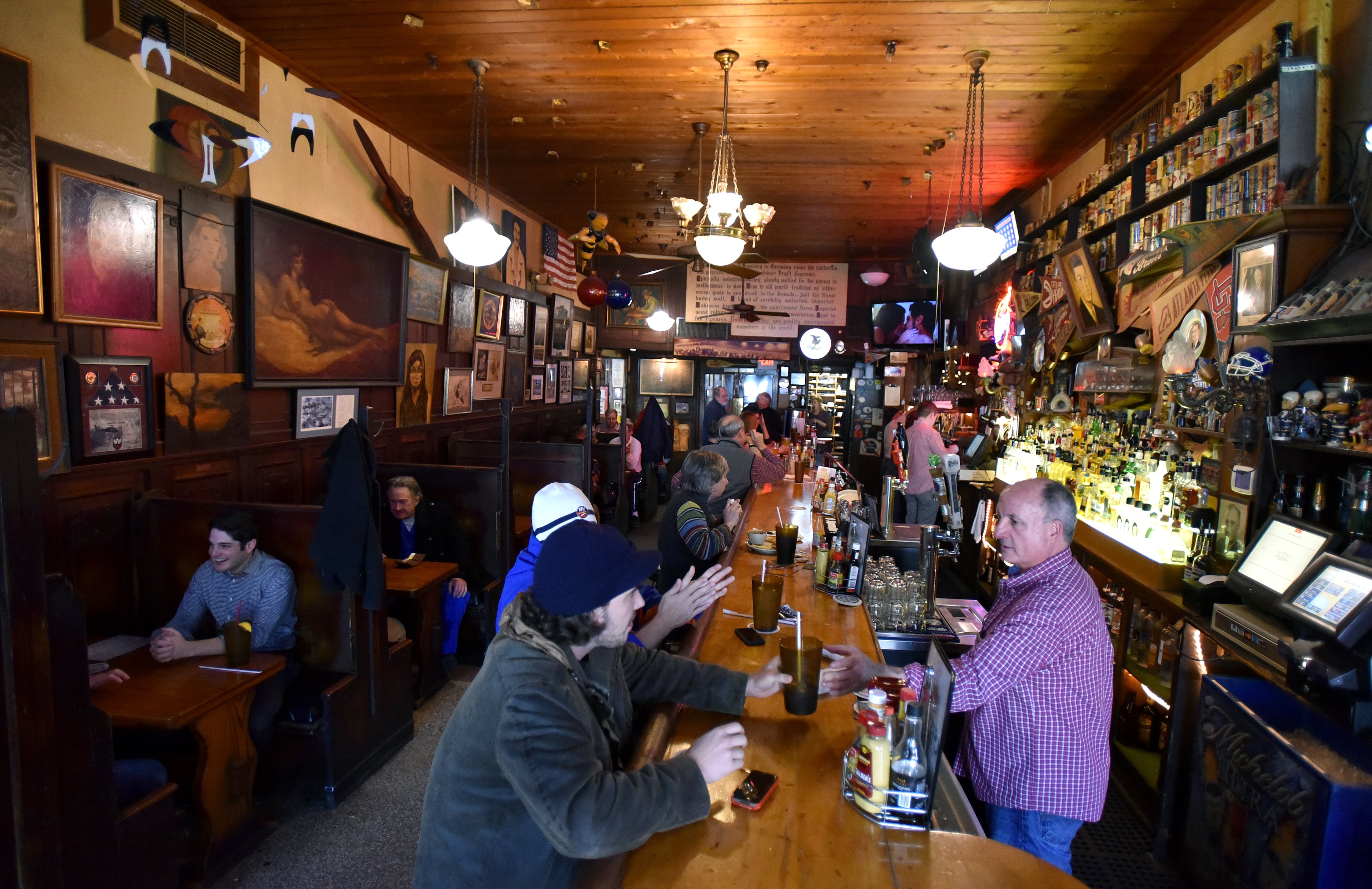A packed crowd of lunch goers at Manuel's Tavern on Friday, February 27, 2015. Manuel's Tavern - the Poncey-Highland bar and decades-old haunt for politicos, reporters and regular in-towners - plans to close for extensive renovations that will coincide with construction of a large mixed-use development. It's a risky move for the storied tavern, closing to redo a classic dive, and hope the customers return. Will loop in why this is being done, the nearby development to come and the tavern's political history. HYOSUB SHIN / HSHIN@AJC.COM