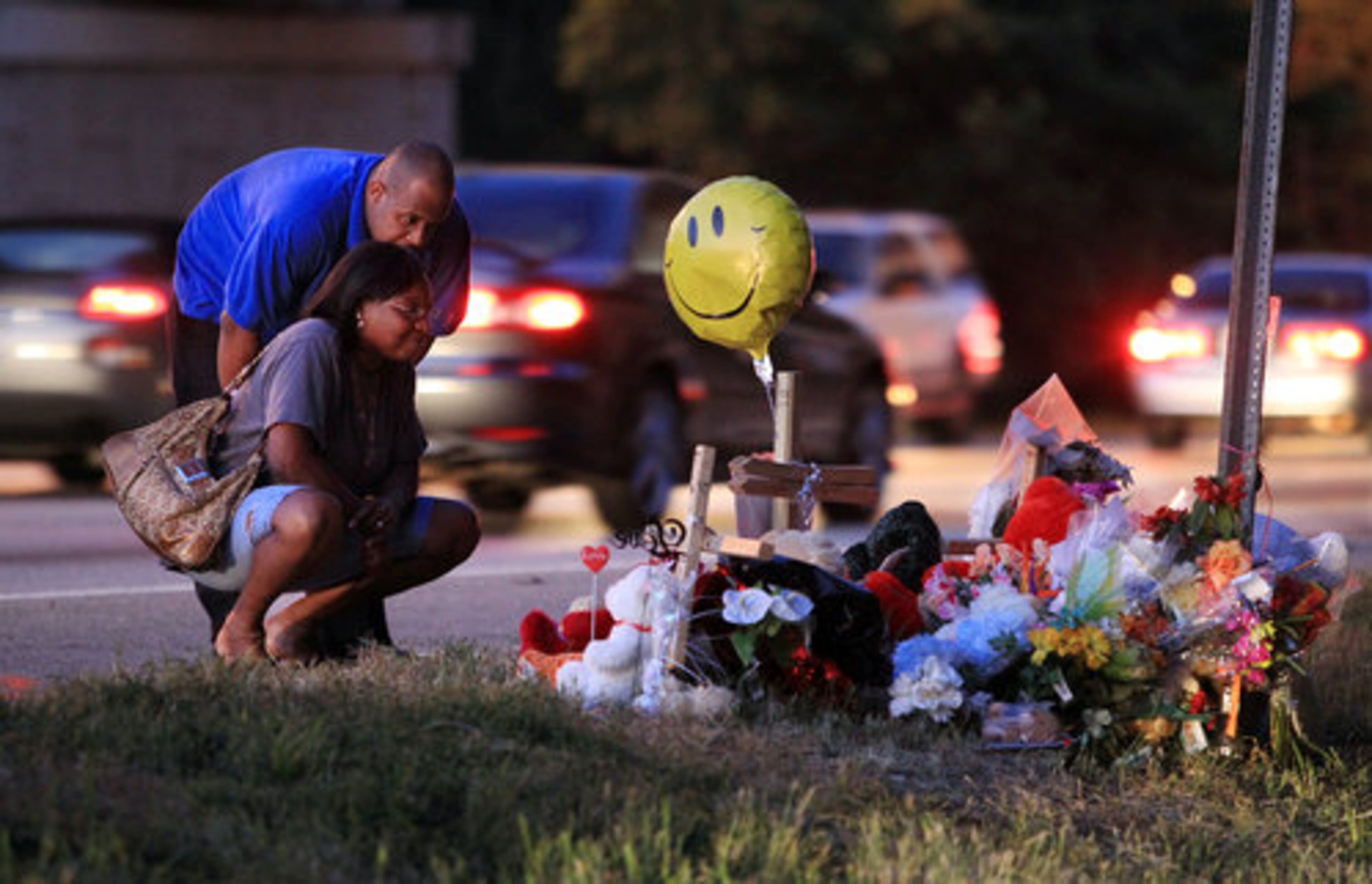 Family friends Anna and John James of Jonesboro stop to pay their respects at the roadside shrine.