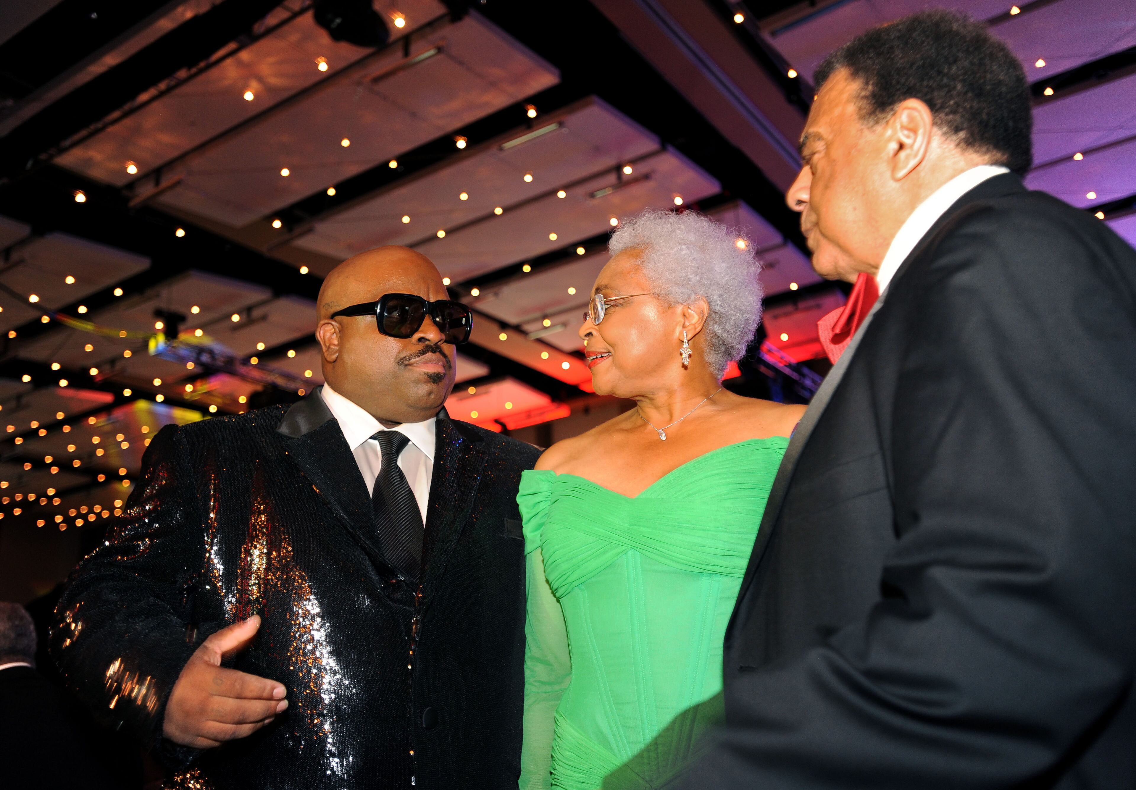 CeeLo Green, left, joins Mayor's Masked Ball co-founder Billye Aaron and former Atlanta Mayor Andy Young, right, at the Marriott Marquis for the annual United Negro College Fund benefit on Dec. 21, 2013, in Atlanta.