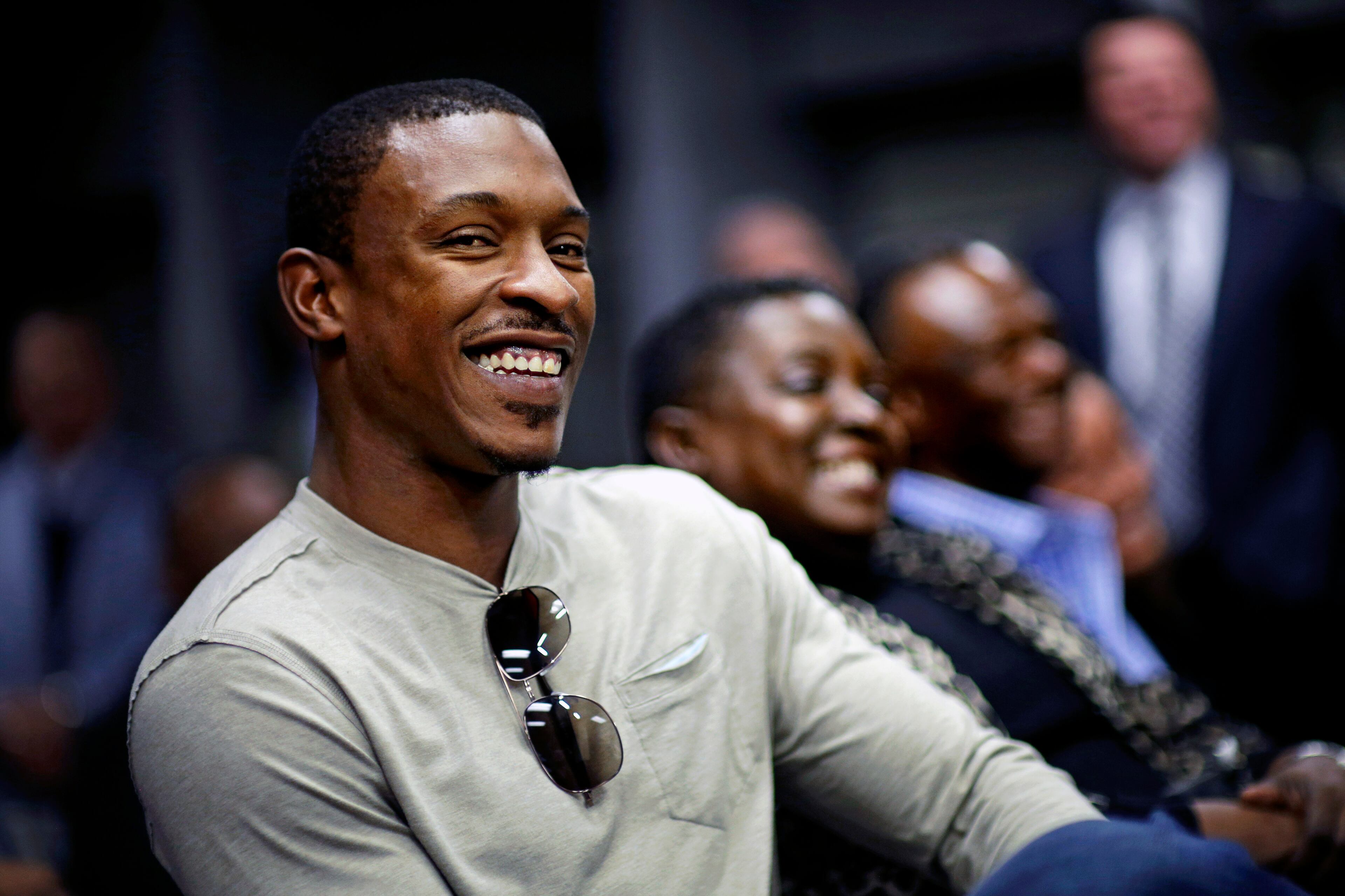 Atlanta Braves' B.J. Upton, who signed a five-year, $75.25 million contract with the Atlanta Braves in November, sits with his mother Yvonne Upton, rear center, and father Melvin Upton, rear right, as his younger brother Justin Upton, not pictured, is introduced as a new Braves player during a baseball news conference on Tuesday, Jan. 29, 2013, in Atlanta. Justin Upton was acquired from the Arizona Diamondbacks in a seven-player deal last week. (AP Photo/David Goldman)
