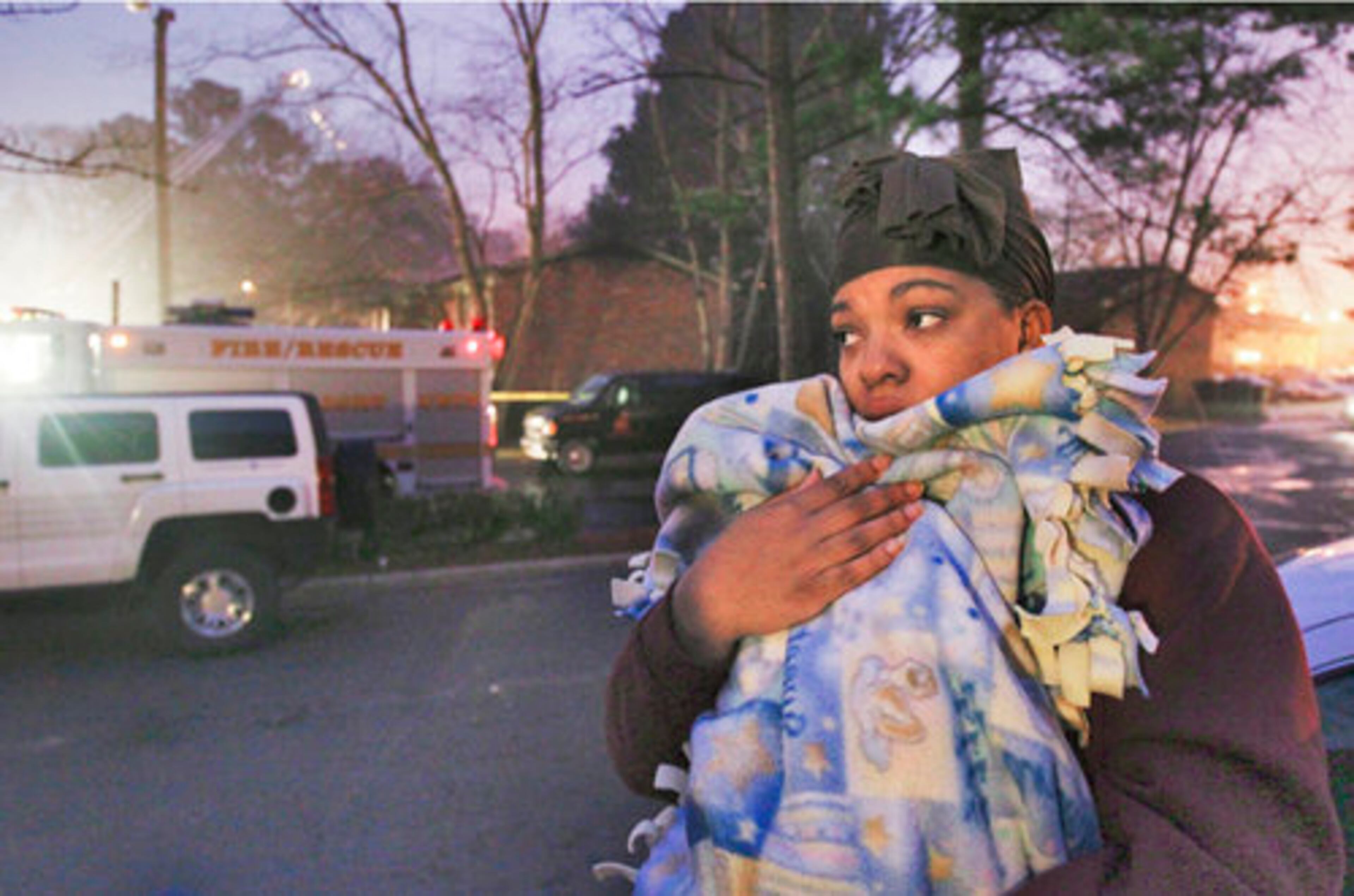 Displaced resident Antoinette Nicholson holds 4-month old daughter, Timyah. She and her fiance Thomas Mosley and son, Timothy, 15 months old (not pictured) were burned out of their apartments Tuesday and lost everything.