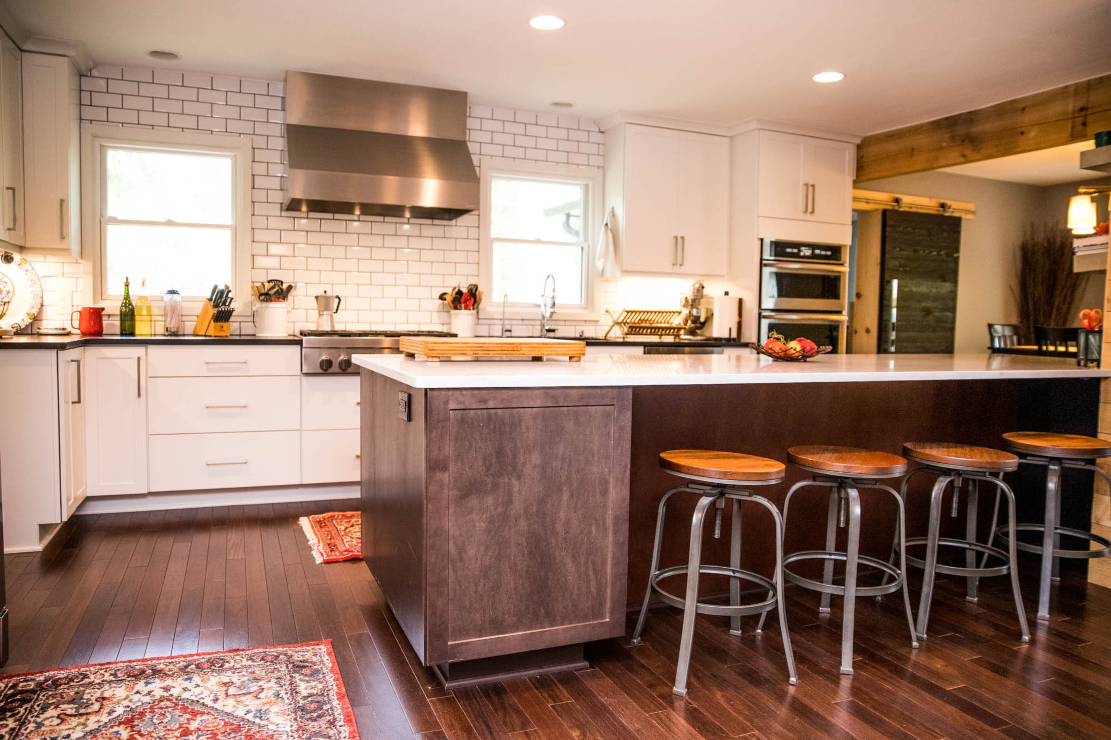 Ben Ratossa loves to cook, and his husband, Adam Perry, loves to bake, so it made sense that when they renovated their kitchen they made it as spacious and functional as possible, including one of Perry's favorite features of the home - a large island uncluttered by appliances or a sink, topped with Polarstone Carrara Quartz counters by AGM Imports Granite & Marble.